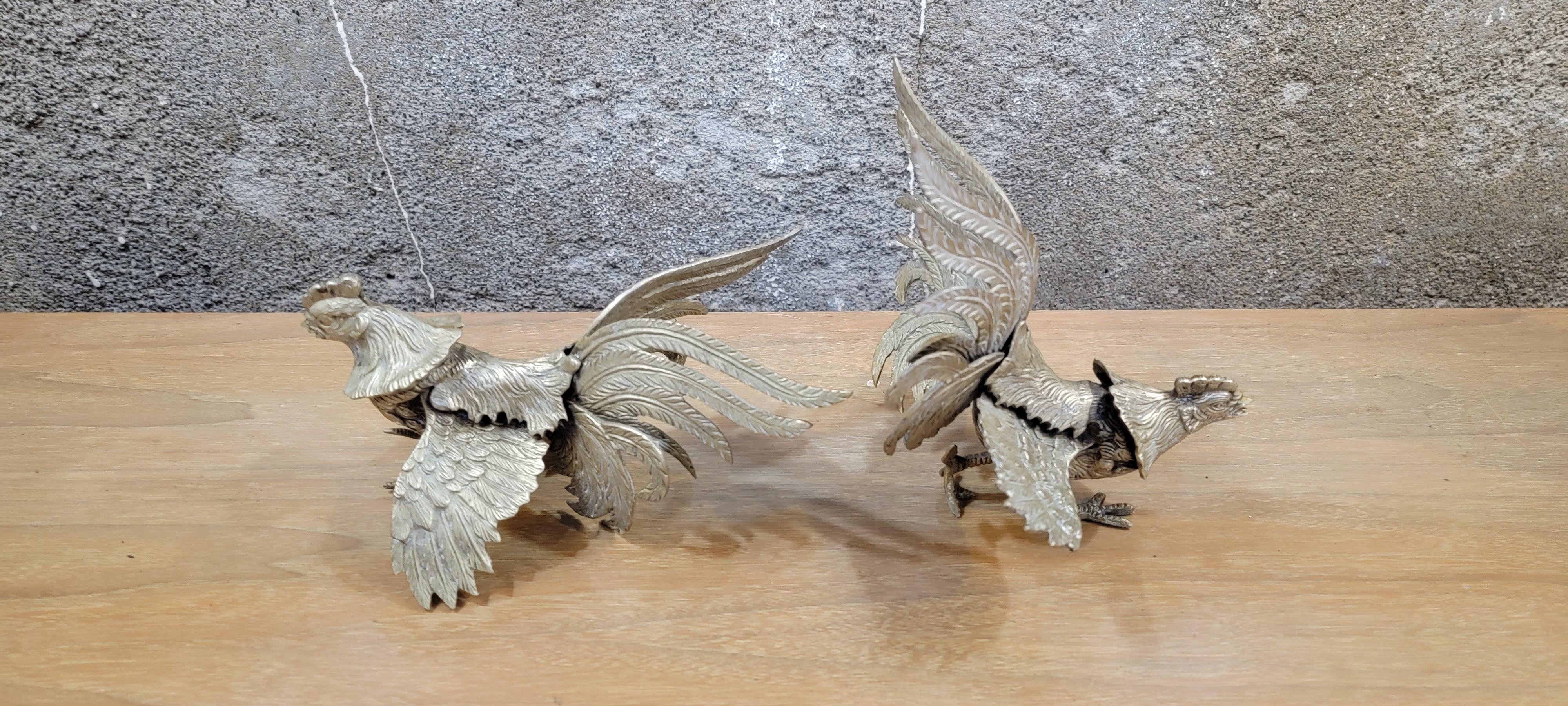 A vintage pair of sculptural brass fighting roosters. Fine detail to feathers. Excellent original condition. Each rooster measures approximately 7