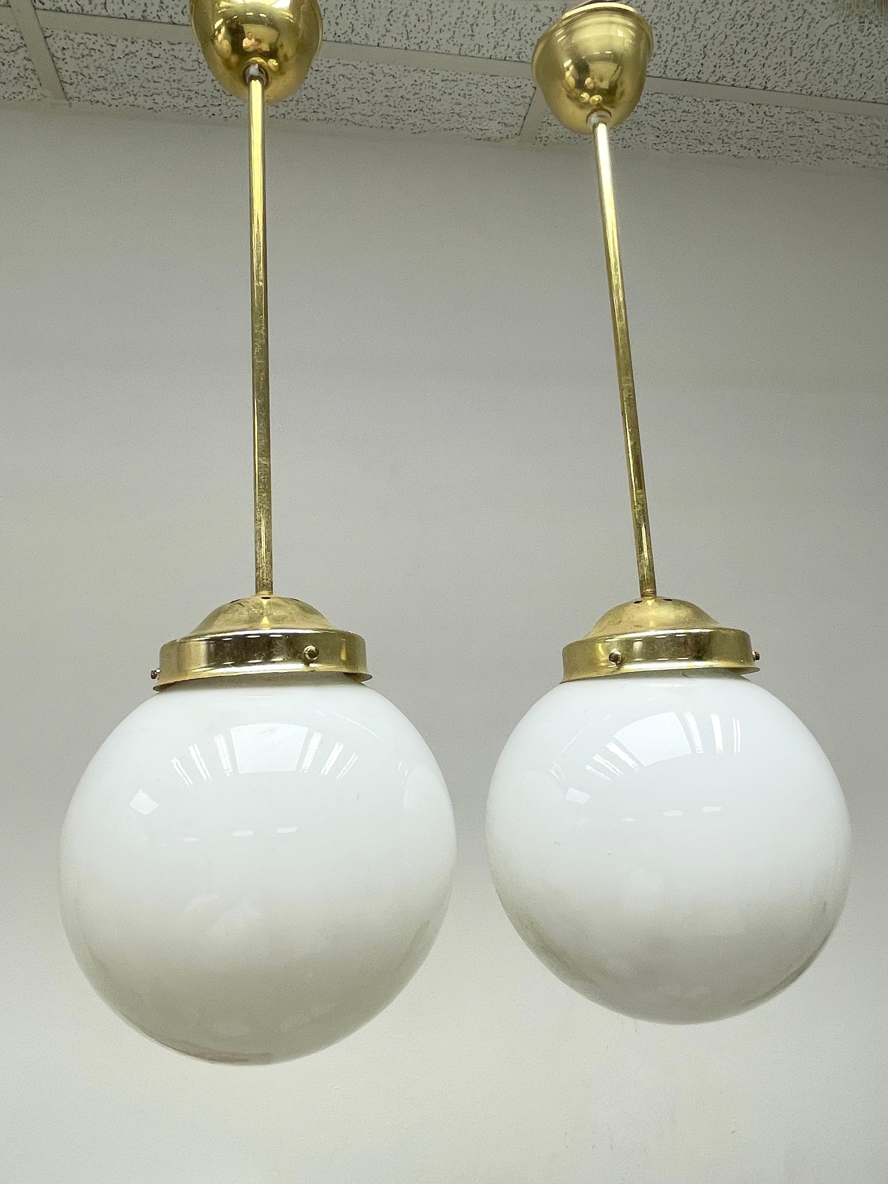 Mid-20th Century Pair Brass Fixture Pendant Milk Glass Ball Art Deco Style Vintage, Austria For Sale