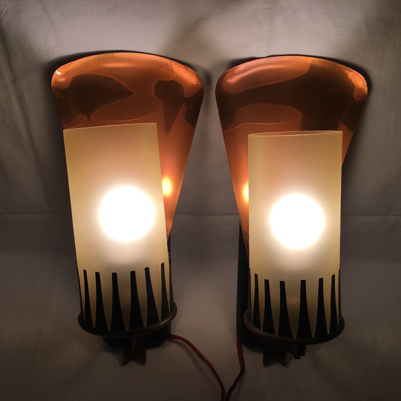 A lovely large imposing pair of Italian designer Gio Ponti styled brass glass 1950s sconces. Made of brass with a round glass cylinder that provides fantastic lighting effect. The glass is held in place by black Iron pointers. Each fixture requires