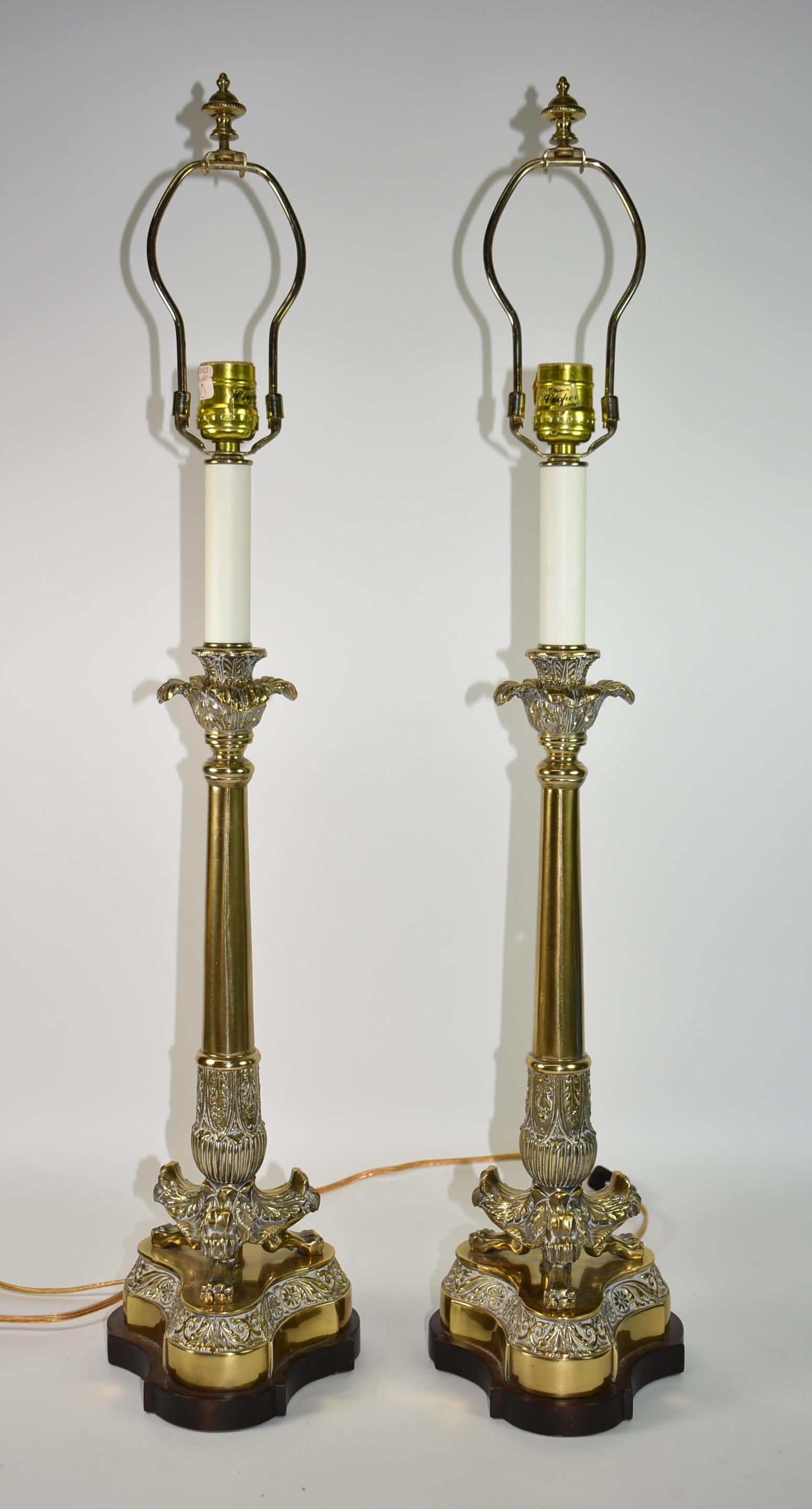 Pair of neoclassical style table/buffet lamps by Frederick Cooper. Heavy brass bases mounted on a wood base. On cord switch. Fringed shades are 14