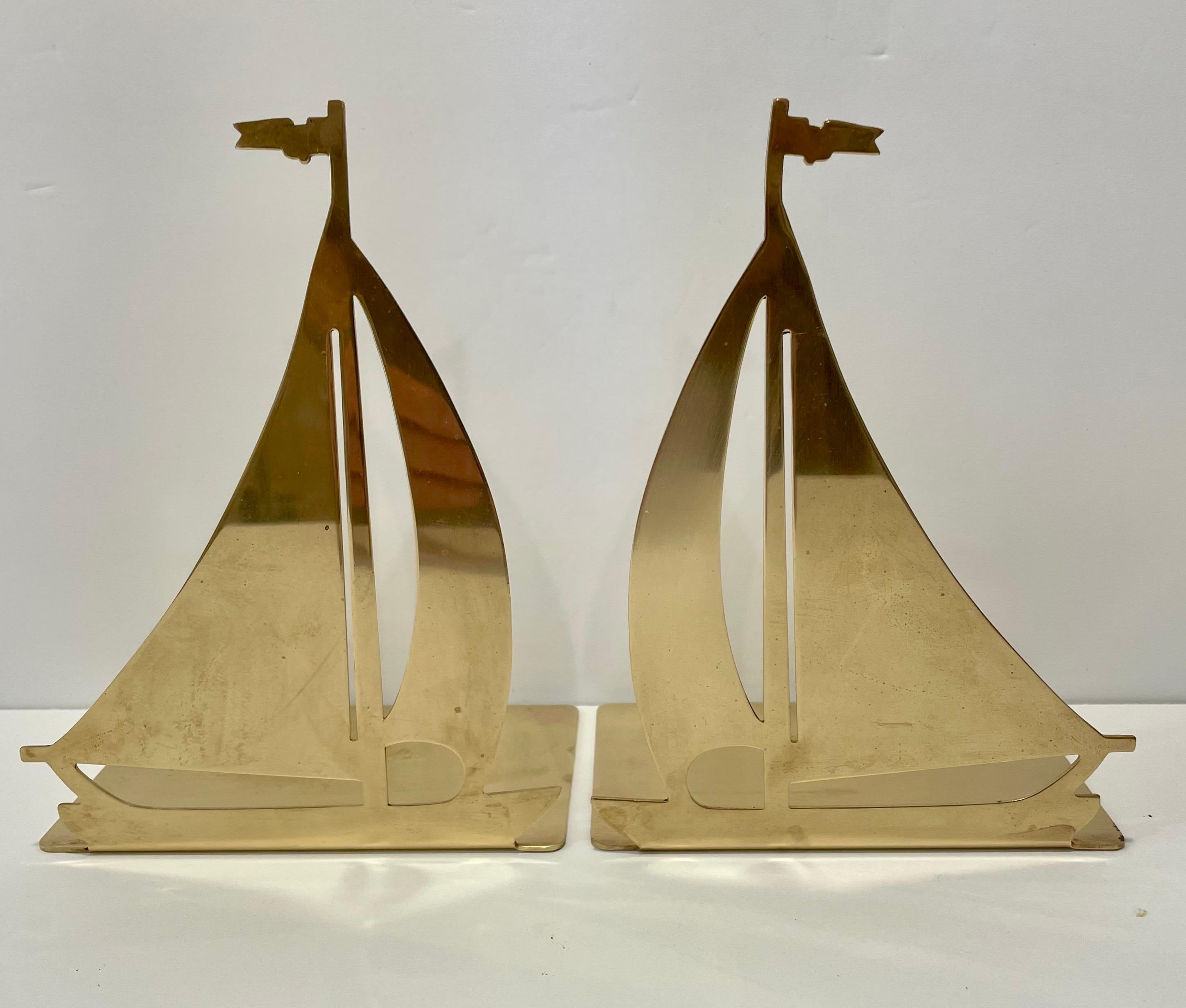 Brass Sailboat bookends. Books sit on top of brass bottoms to hold a shelves worth of books. Good overall condition, some slight patina. Thin pad on bottom to protect surfaces. Any dark or light spots are reflection only. Great for your beach house!