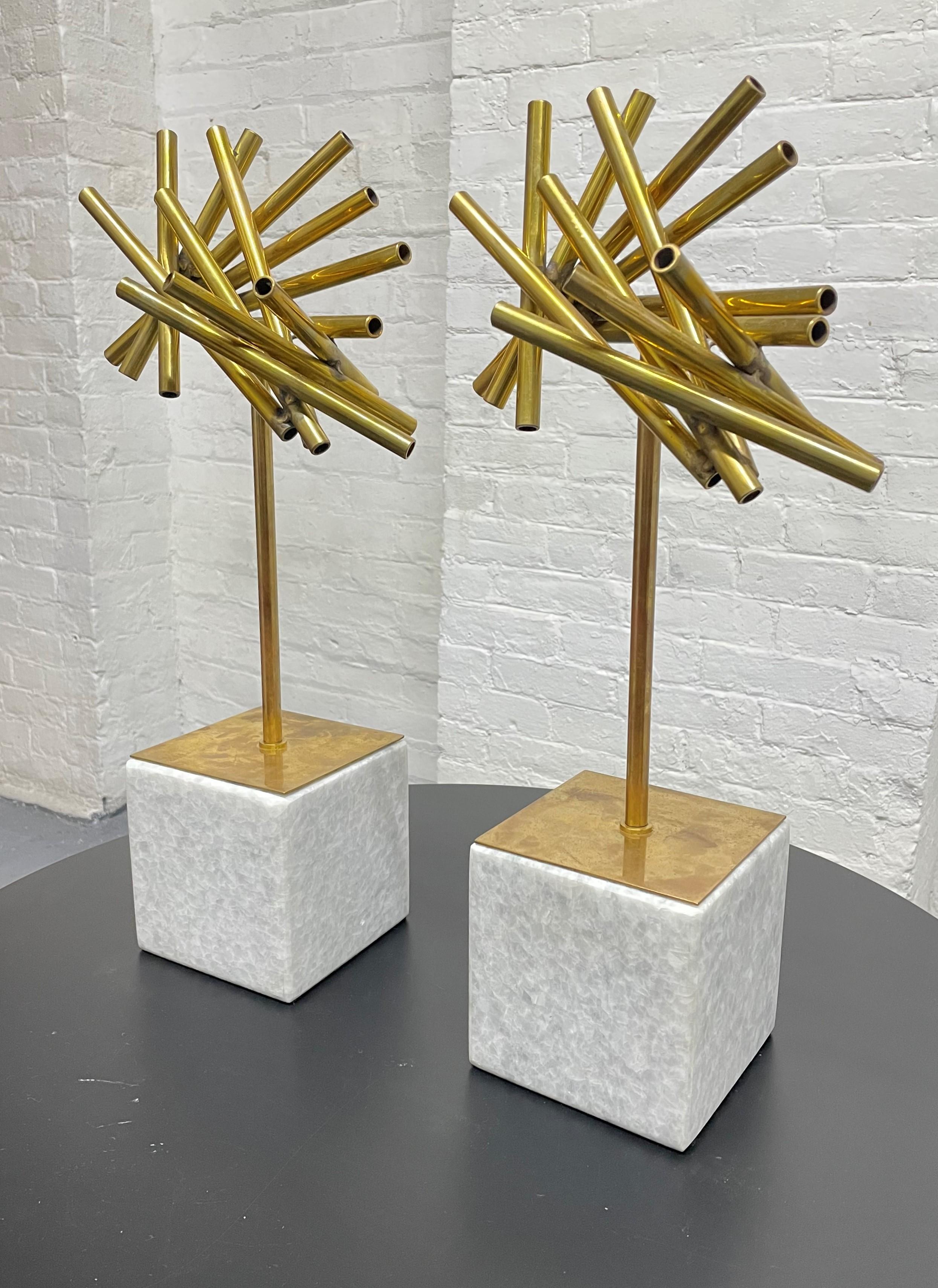 Pair brass sculptures on marble bases.