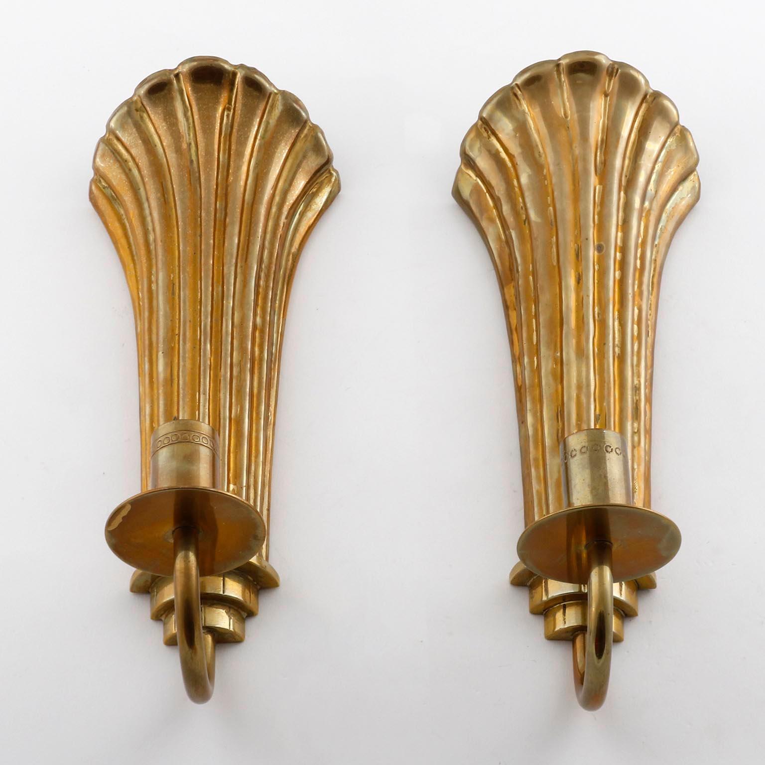 A pair of Art Deco brass one-light wall sconces designed by Lars Holmstrom for Konstsmide Arvika, Sweden, manufactured in 1920s-1930s.
The candle holders are in very good condition with lovely patina on brass.