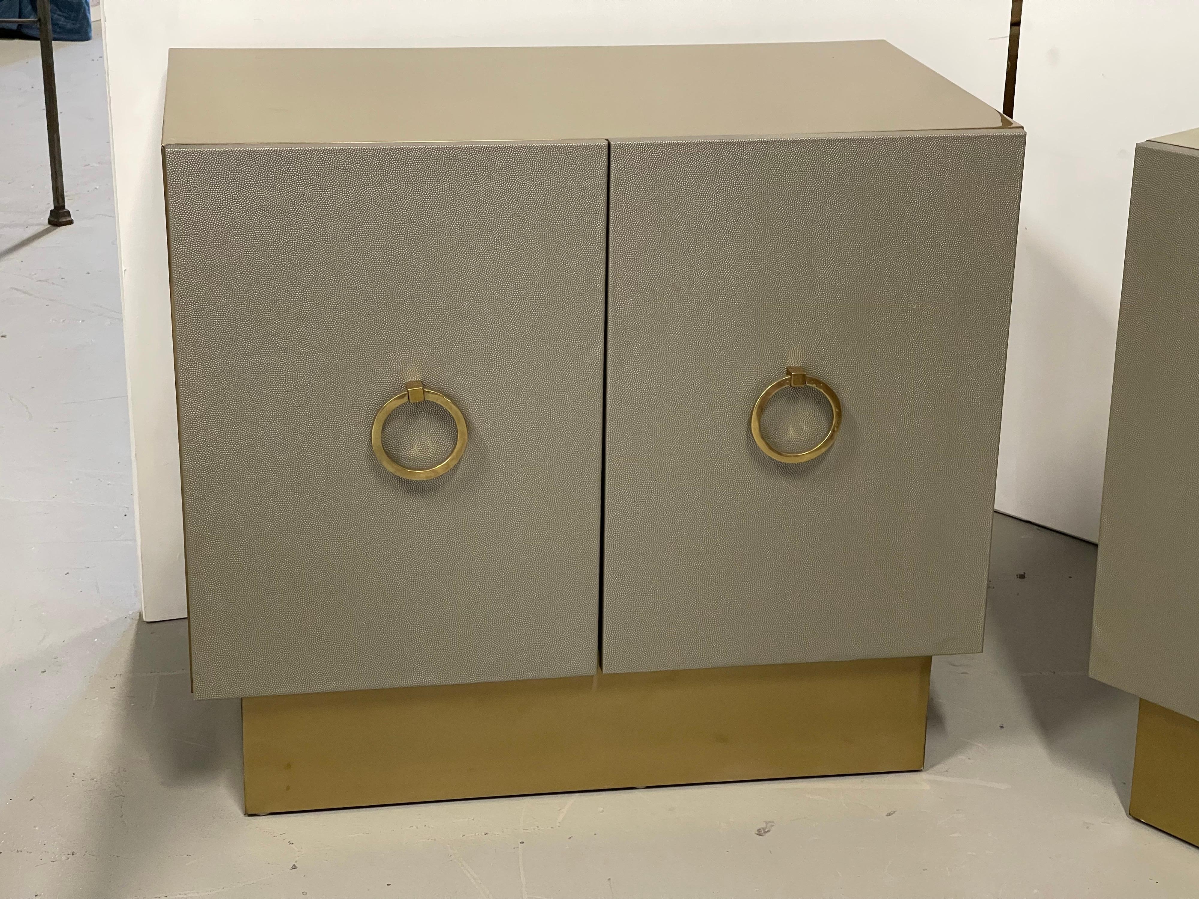 A pretty pair of custom Bridges over time custom night stands Made by a local Palm Springs artisan Marco Antonio. The front doors are wrapped in leather. The bodies have a metallic brass finish. Finish interiors are painted grey. One shelf in each.