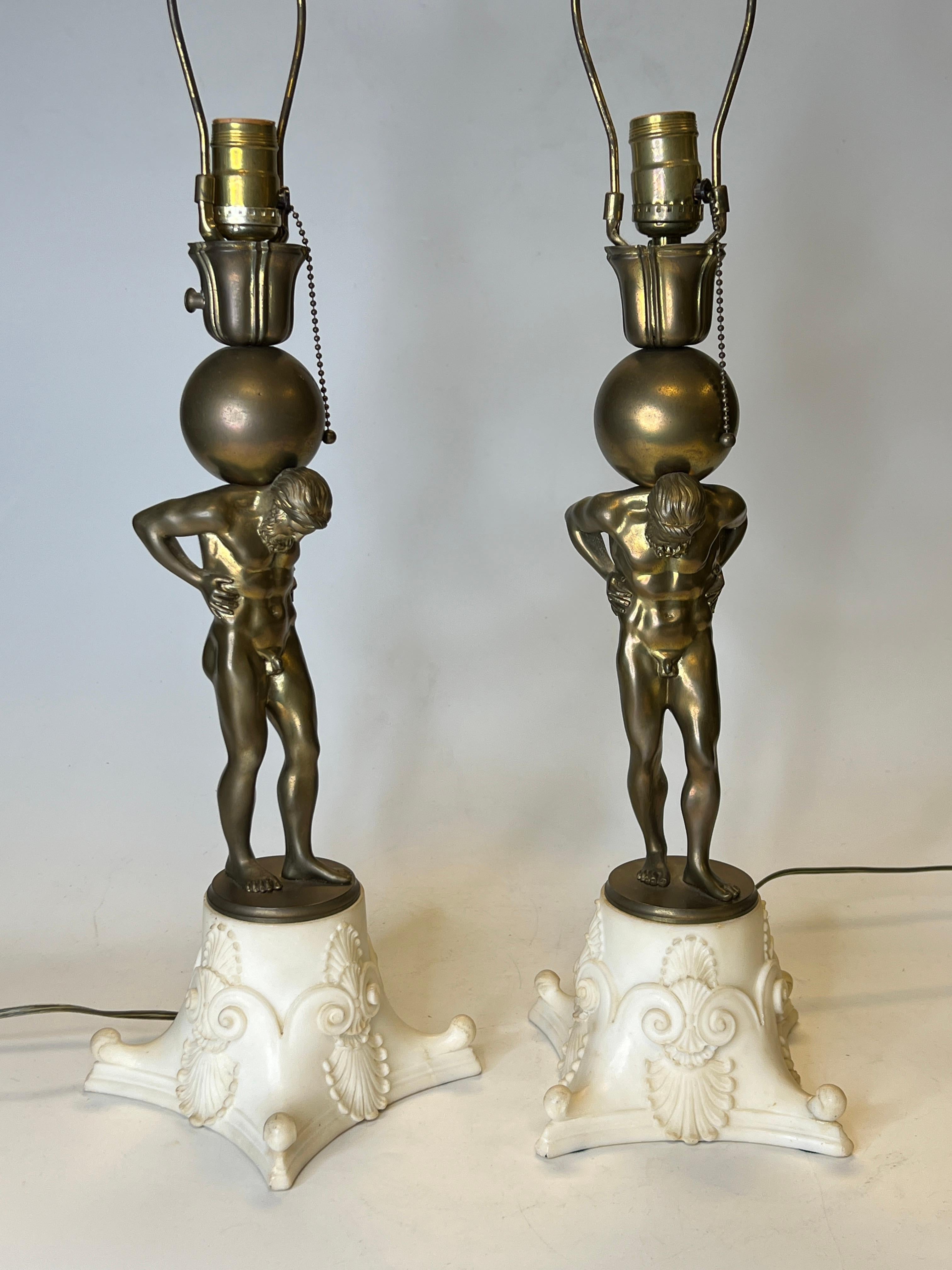 Pair of French bronze and marble figures of atlas mounted as table lamps.