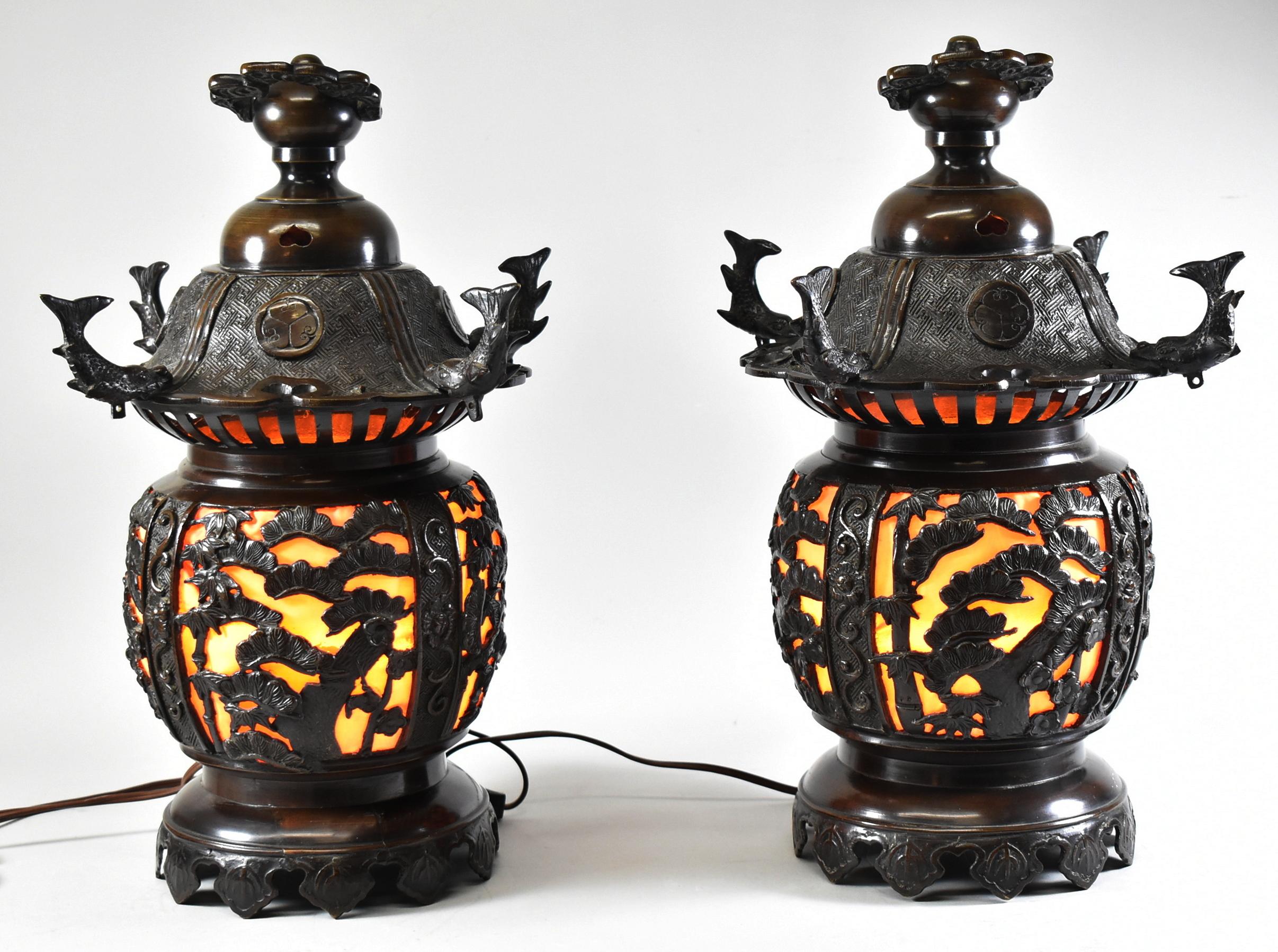 Pair of bronze Asian style reticulated lanterns with a single socket. Figural fish on the cap. Measure: 18