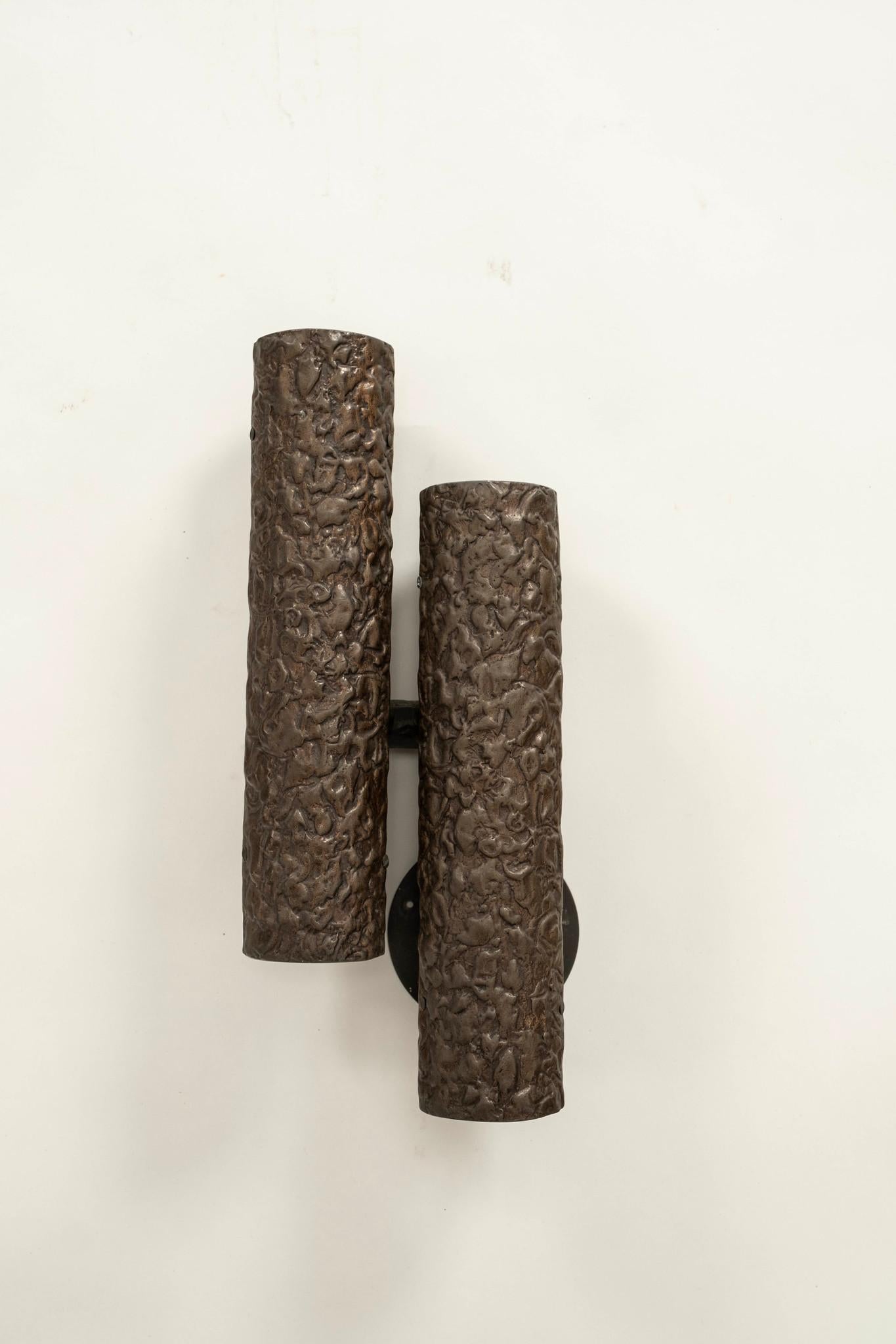 Pair of bronze double-tube Brutalist sconces featuring pebbled texturing.