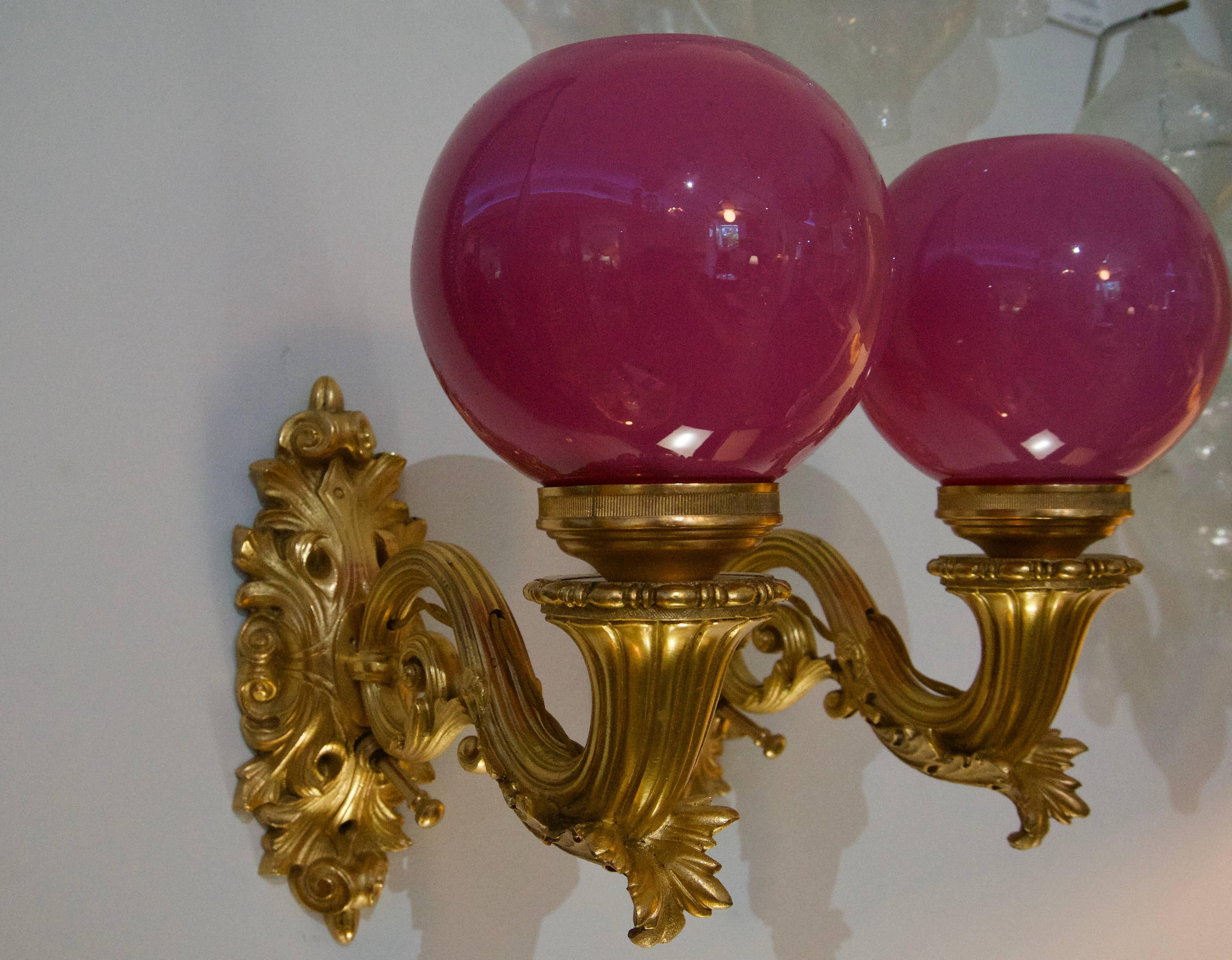 This stylish and chic pair of wall sconces were acquired from a Palm Beach estate and will make a definite statement with their deep fuschia pink globes and gilt gold plating.

Note: These can be hardwired with a wall switch or use the hand switch