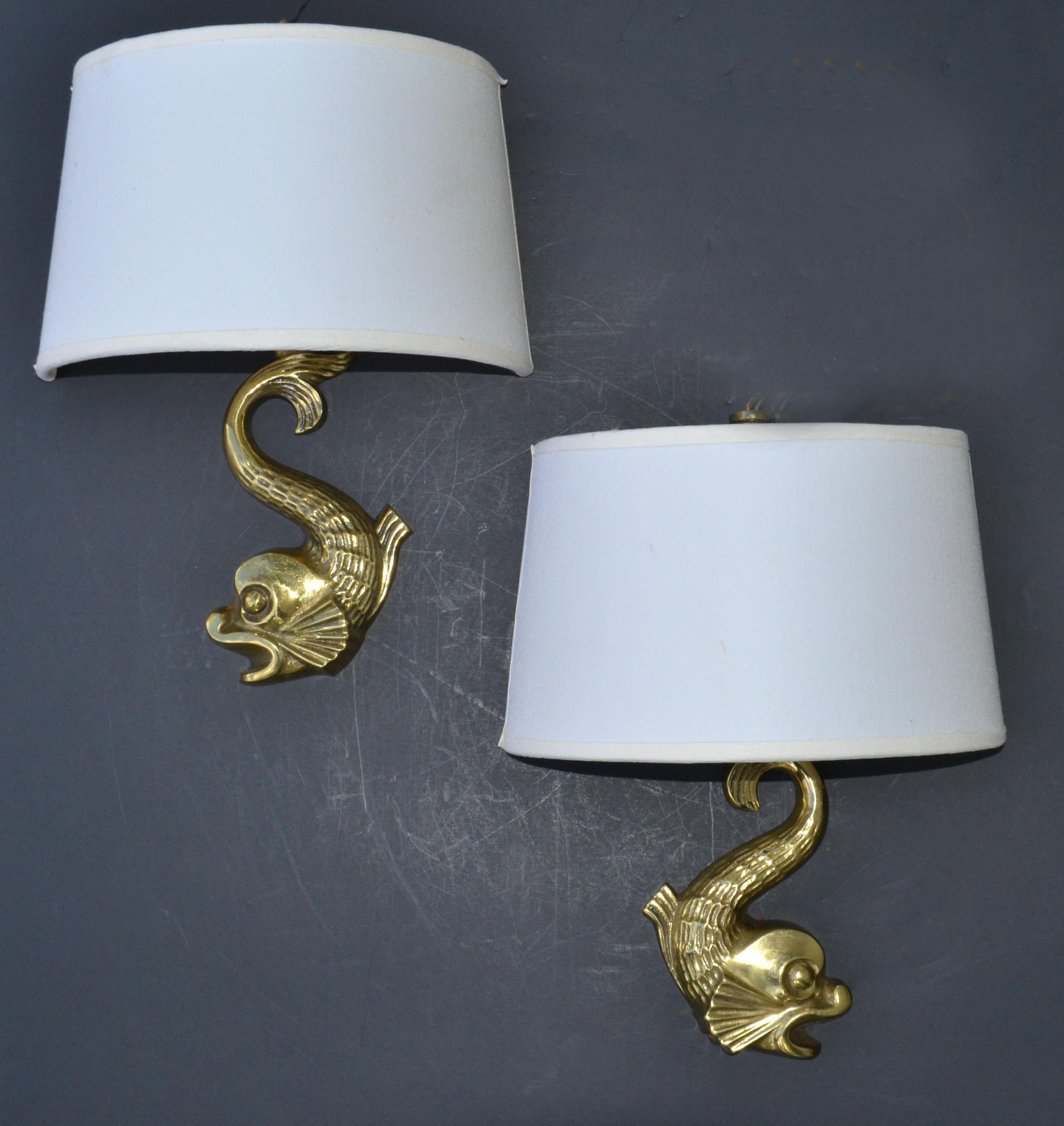 Pair of bronze Dolphin sconces, wall lamps style of E. Guillemard and made in France in the 1950.
In working condition and each takes a max. 60 watts candelabra light bulb.
Sold with newly made Custom Shades.
Measures: 8 x 5 x 4 inches