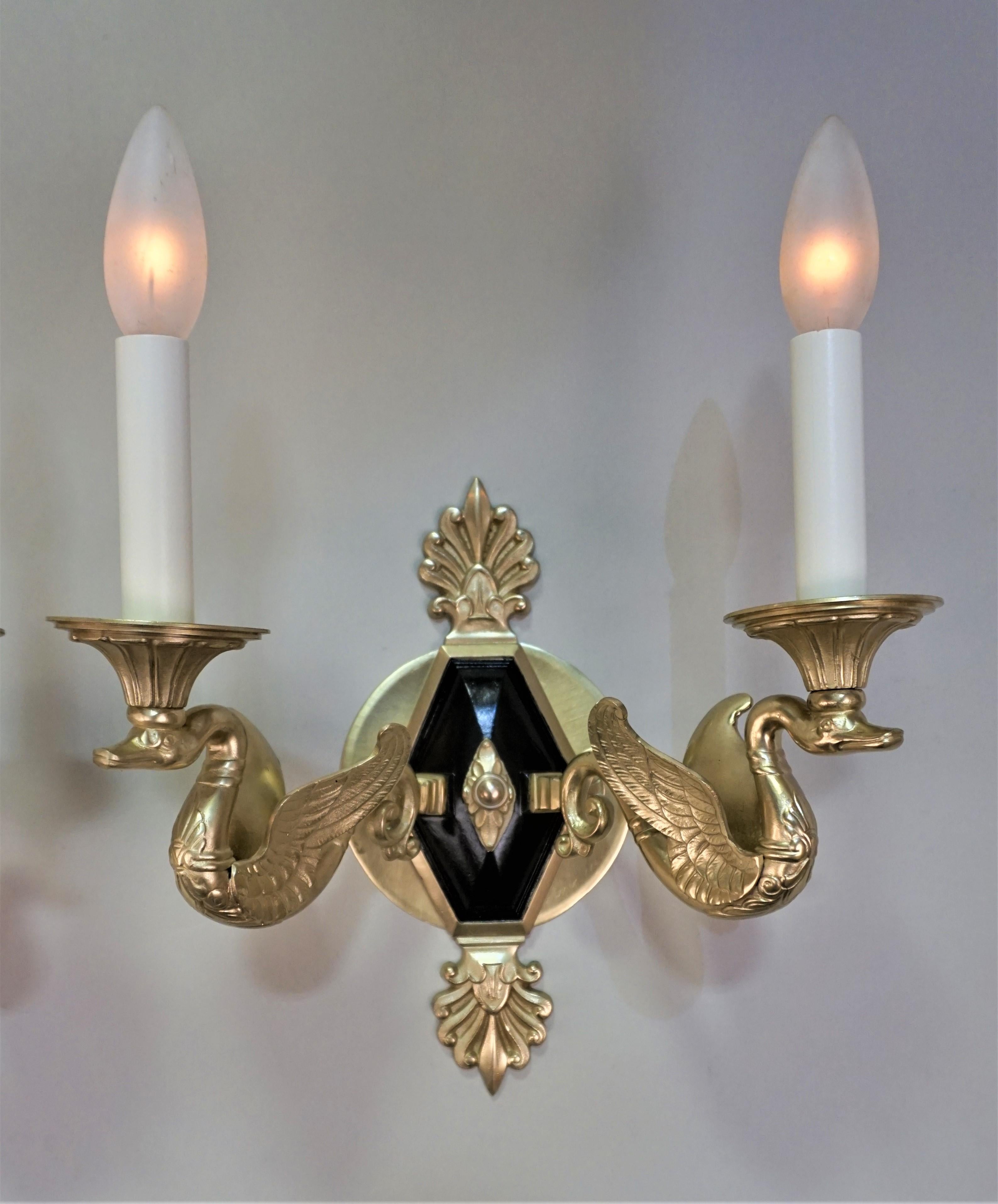 Pair of French 1930's double swan arms empire style bronze wall sconces.