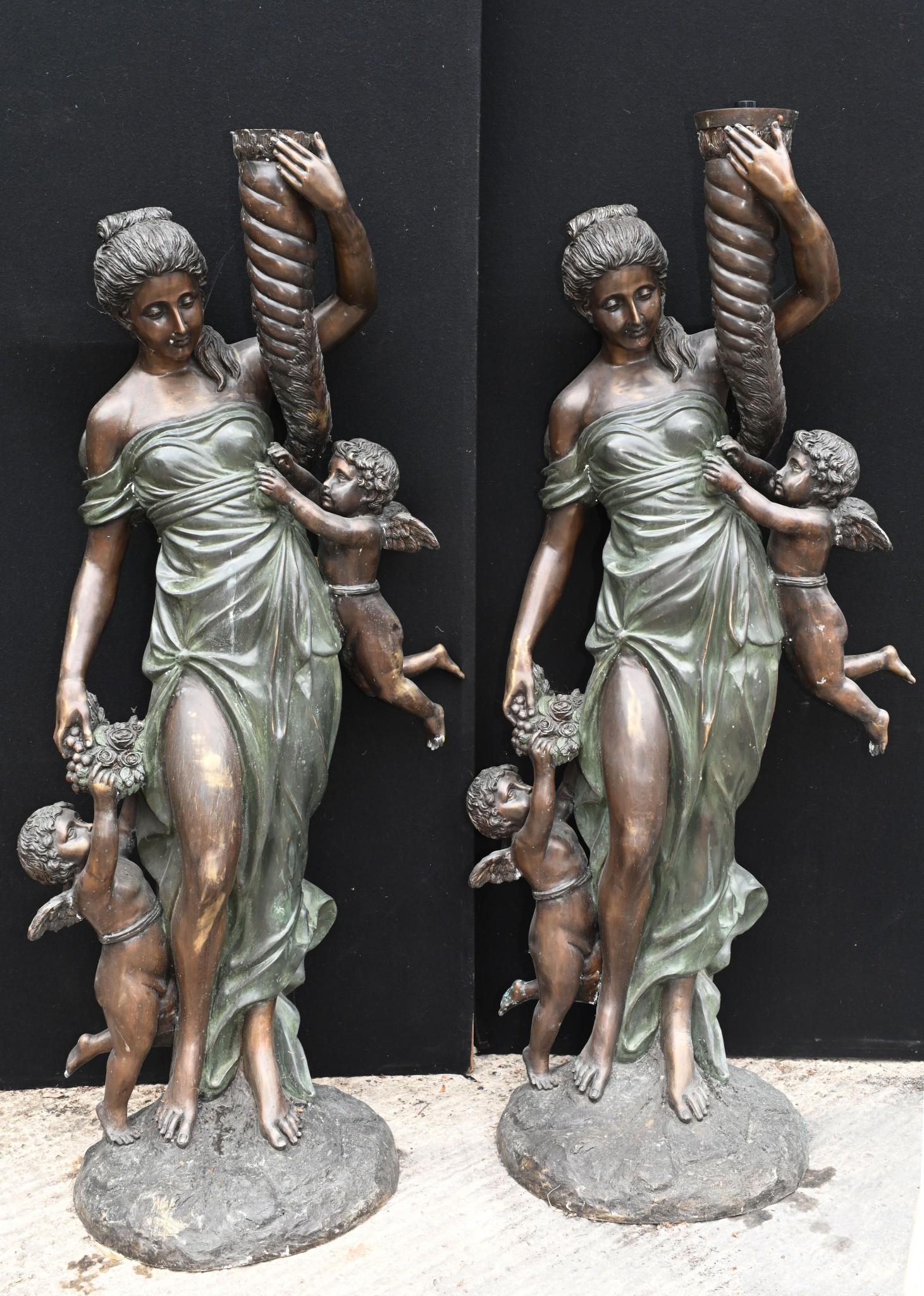 Gorgeous pair of large Italian bronze maidens adorned with cherubs
Each figurine holds the horn of plenty which suggests this might be a representation of Demeter the Goddess of the harvest 
Great casting and a good size at over five feet tall -
