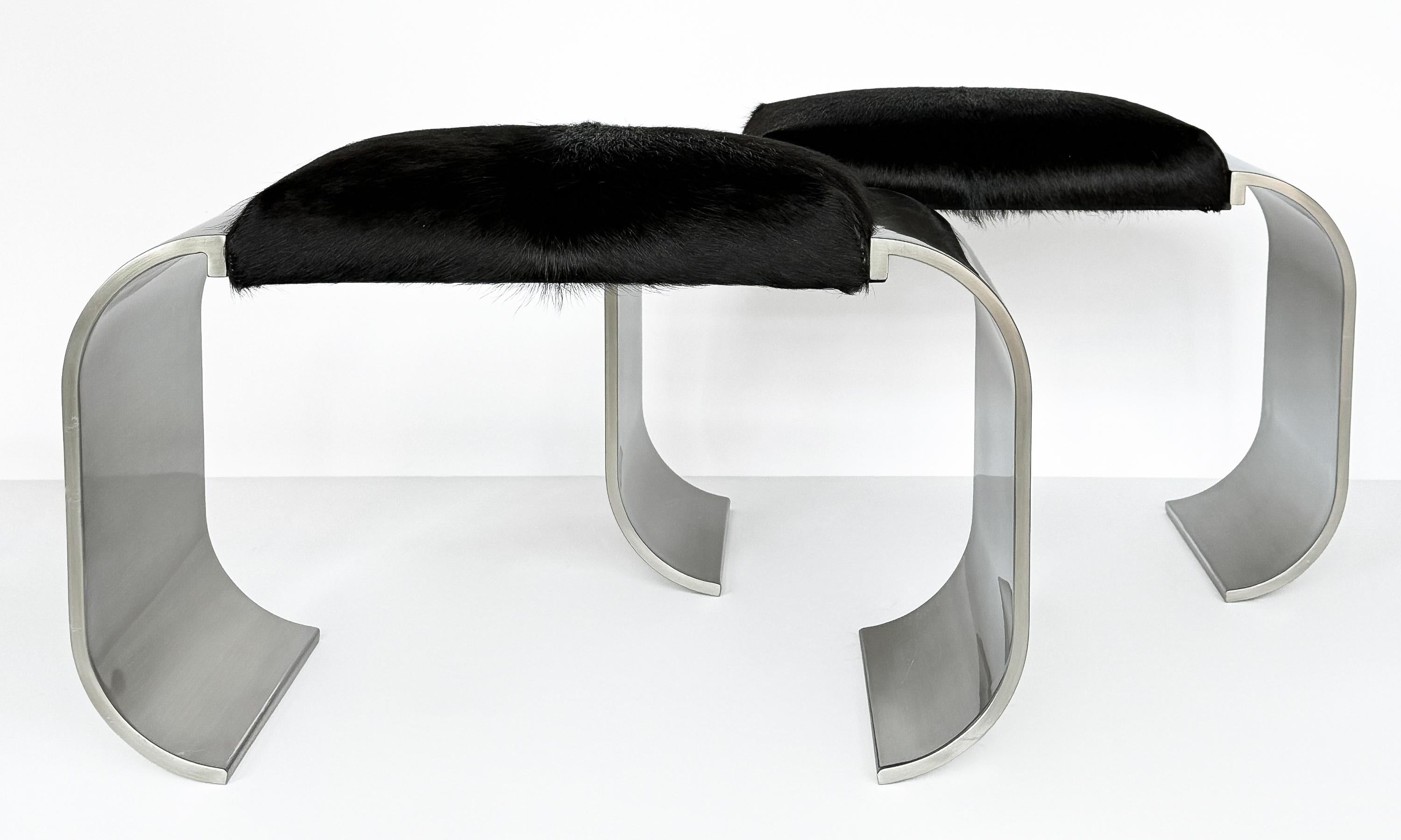 
This pair of “Macao” benches / ottomans by Stanley Jay Friedman for Brueton is a striking example of the seamless fusion of form and function that characterizes 1970s American design. Crafted with the durability and luster of thick stainless steel,