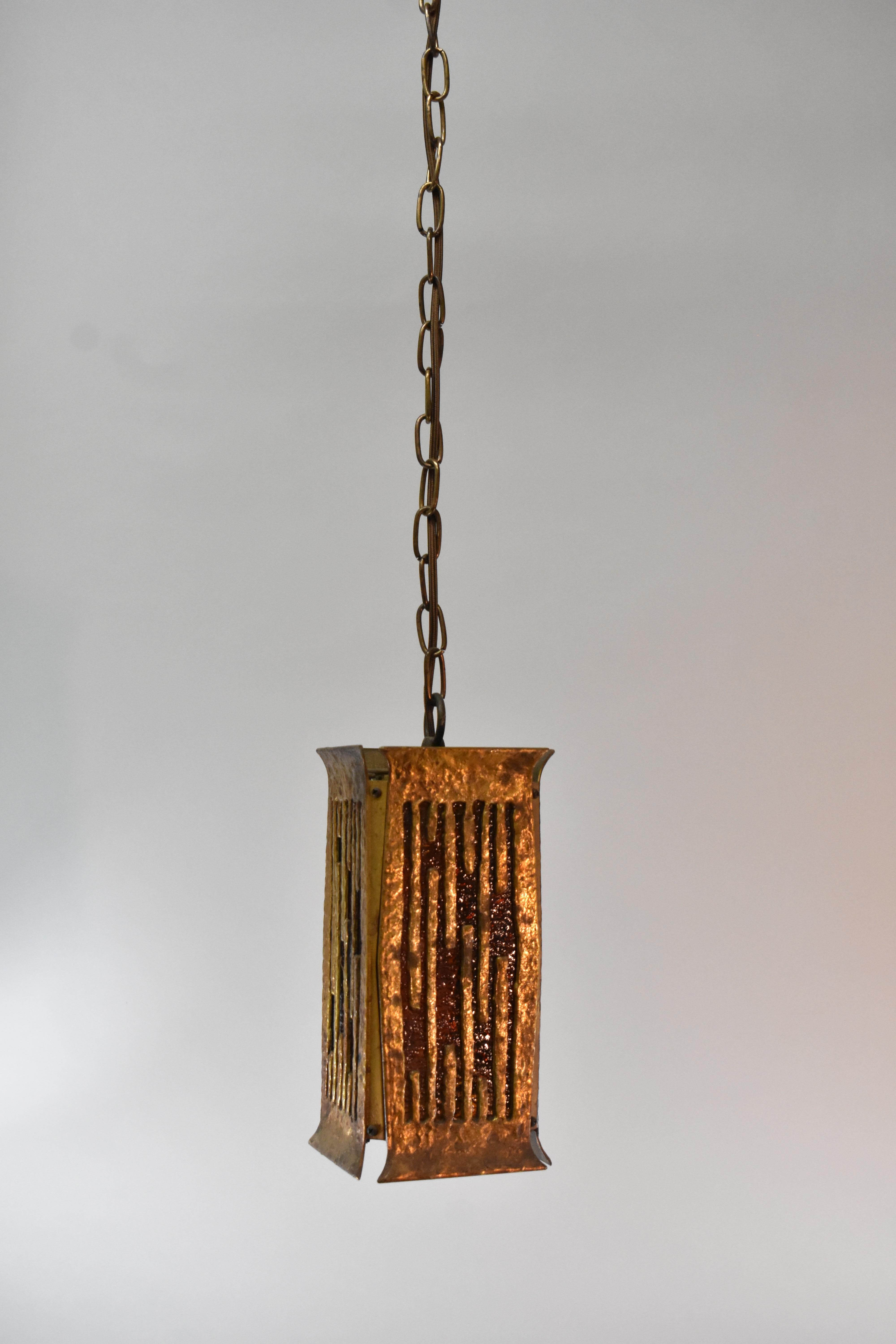 Pair of heavy cast brass Brutalist style porch or hall lanterns. Hammered finish with amber granite back glass inserts.