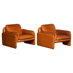 Paire de chaises longues Brutalist DS-61 Cognac avec une grande patine en cuir par 'De Sede'