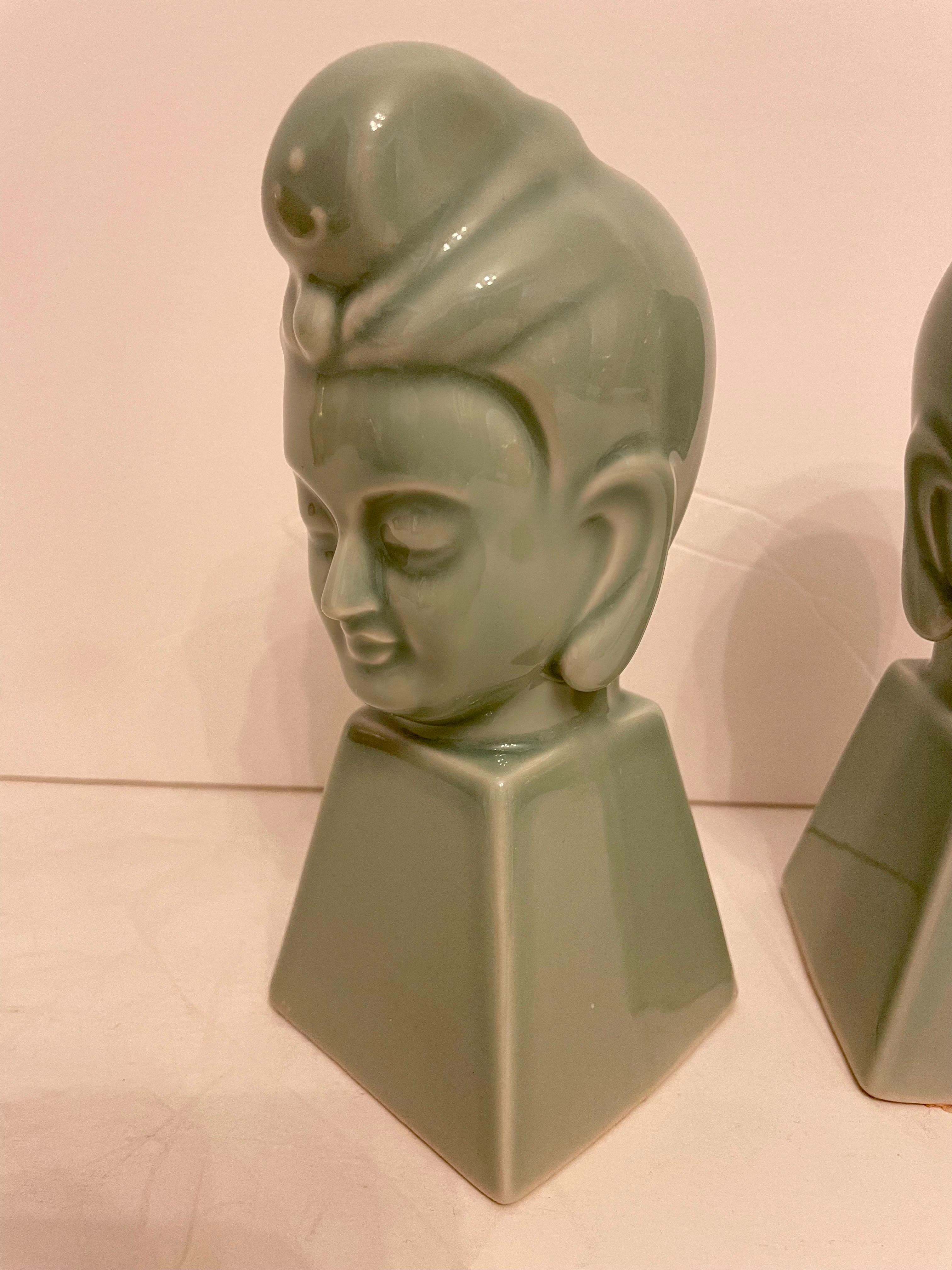 Pair of Ceramic Buddha Sculptures or  Bookends. Nicely detailed, in Good condition. Any dark or light spots are reflection only. Sticker on bottom marked Japan. 7