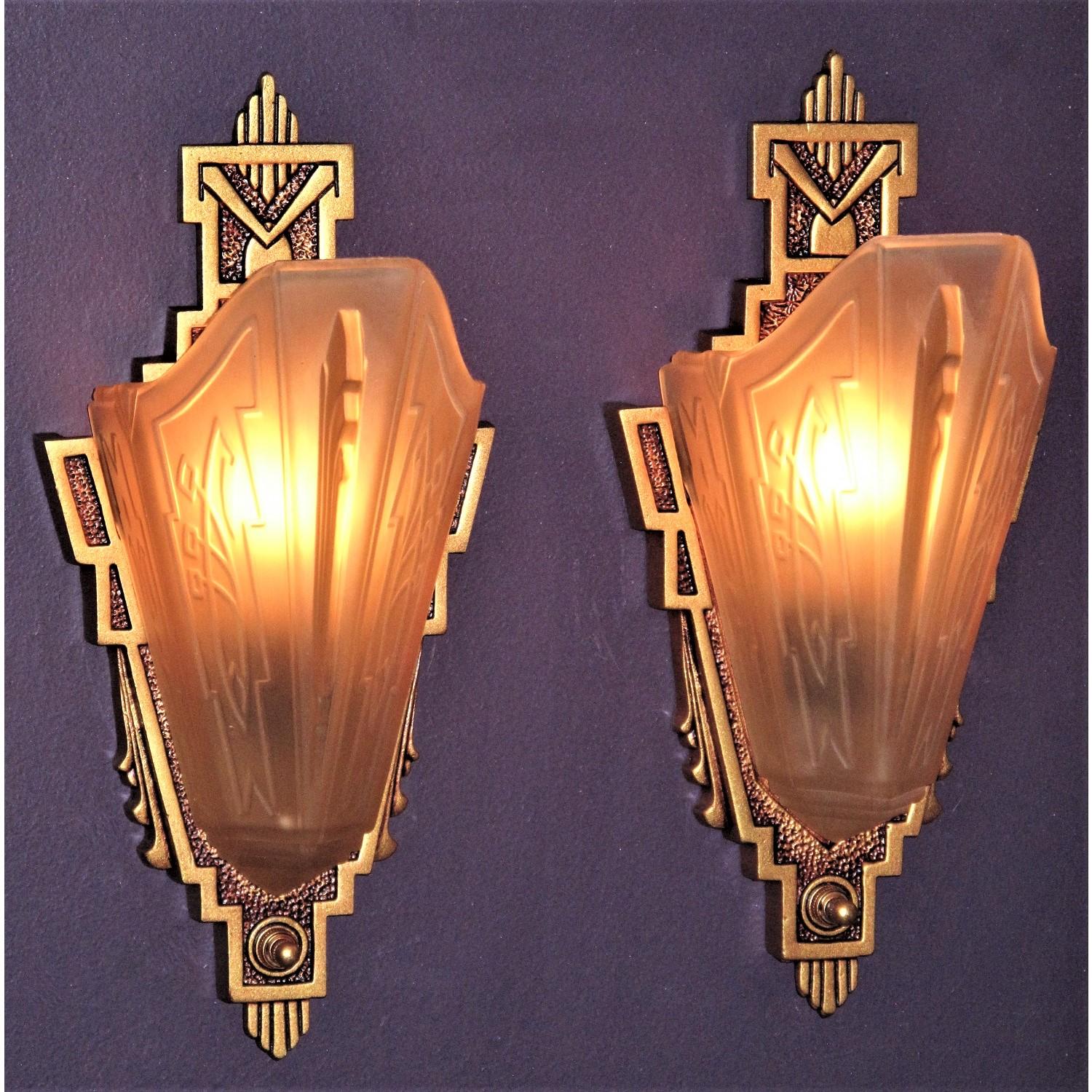 1 Pair available, priced per pair.
Late '20s through mid '30's wall lighting fixtures with a subtle art deco and American Southwest influences. Highly sought after and prized Consolidated Glass Co. shades adorn these refurbished cast iron sconce