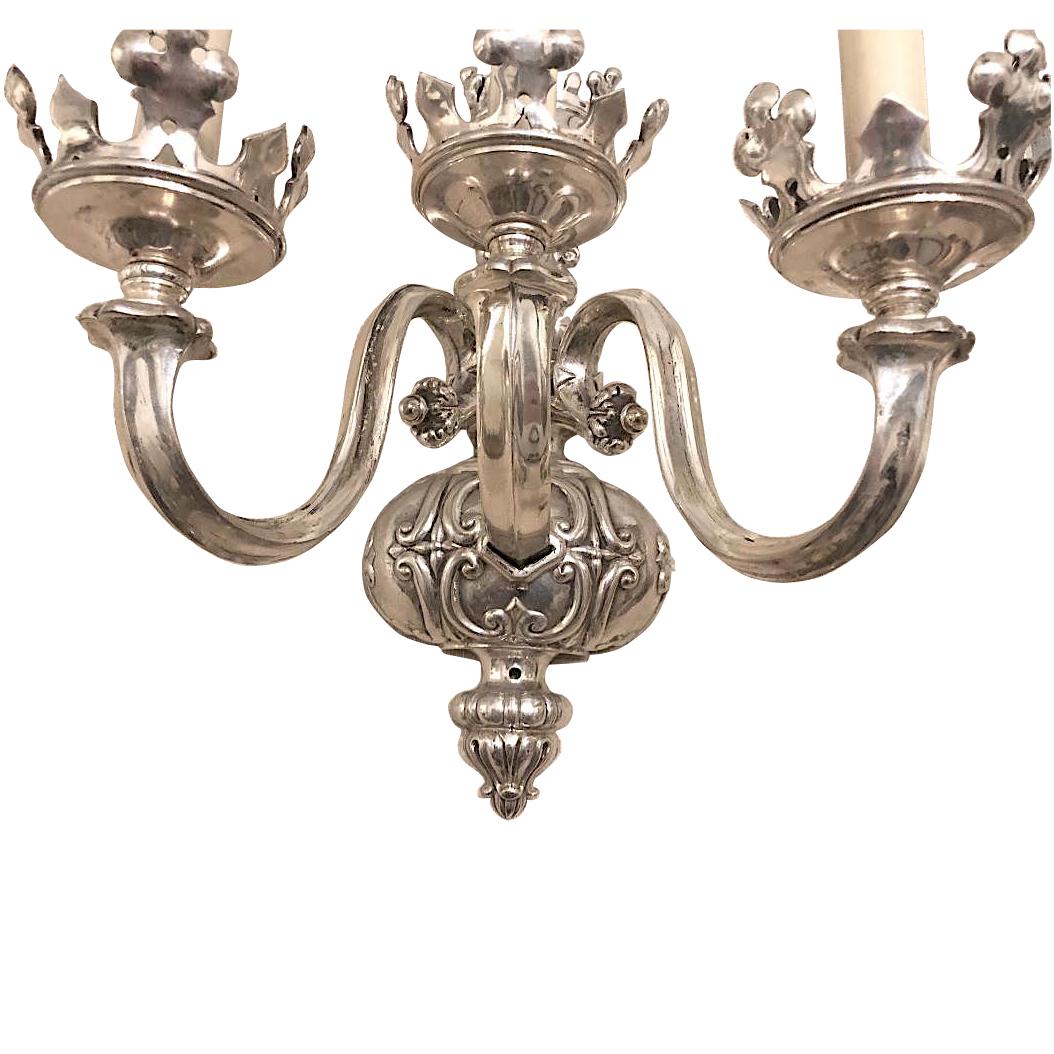 Pair of English circa 1920's silver-plated three-arm sconces with crown motif.

Measurements:
Height 14