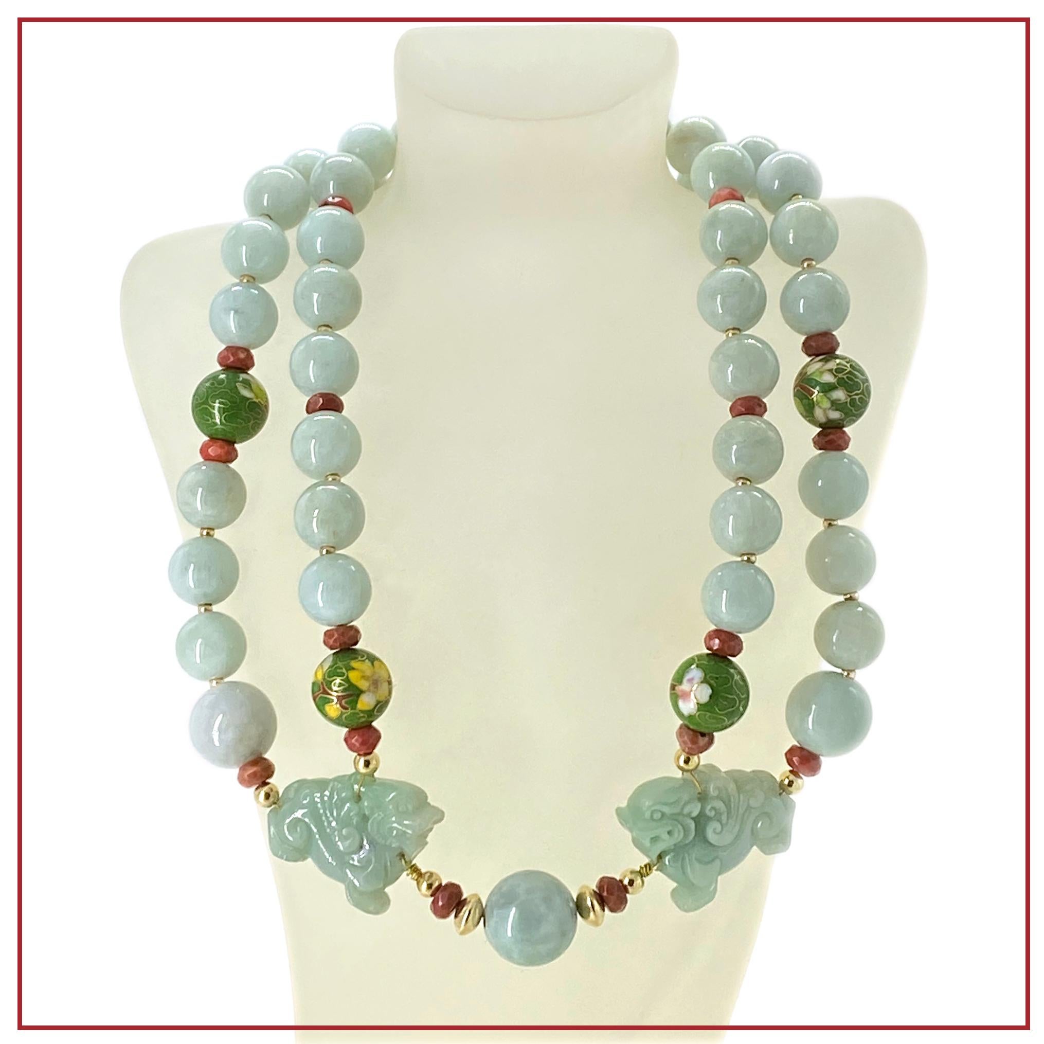 This is a double strand jade necklace with Foo Dogs. We created it with 13mm grade A light green jadeite and decorated it with 15mm vintage cloisonné beads and 8mm faceted natural coral faceted rondels. The necklace is brass wired with a pair of