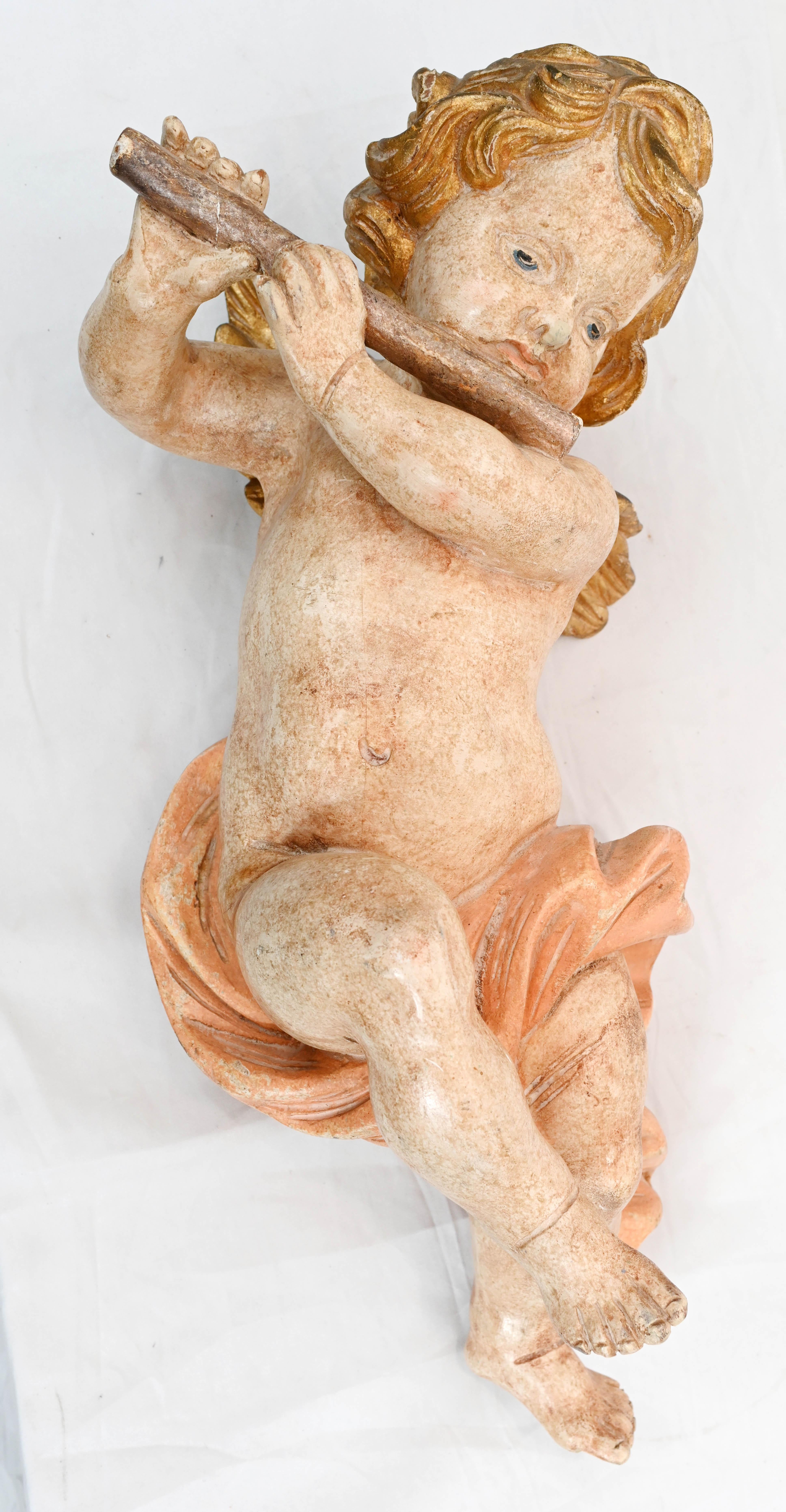 Absolutely gorgeous pair of Italian carved cherubs 
Cherubs are of the lovely chubby variety and are playing musical implements
Great as a wall hanging
Cherubs are painted with lovely skin tones and colours
Possibly salvaged from a church
Some