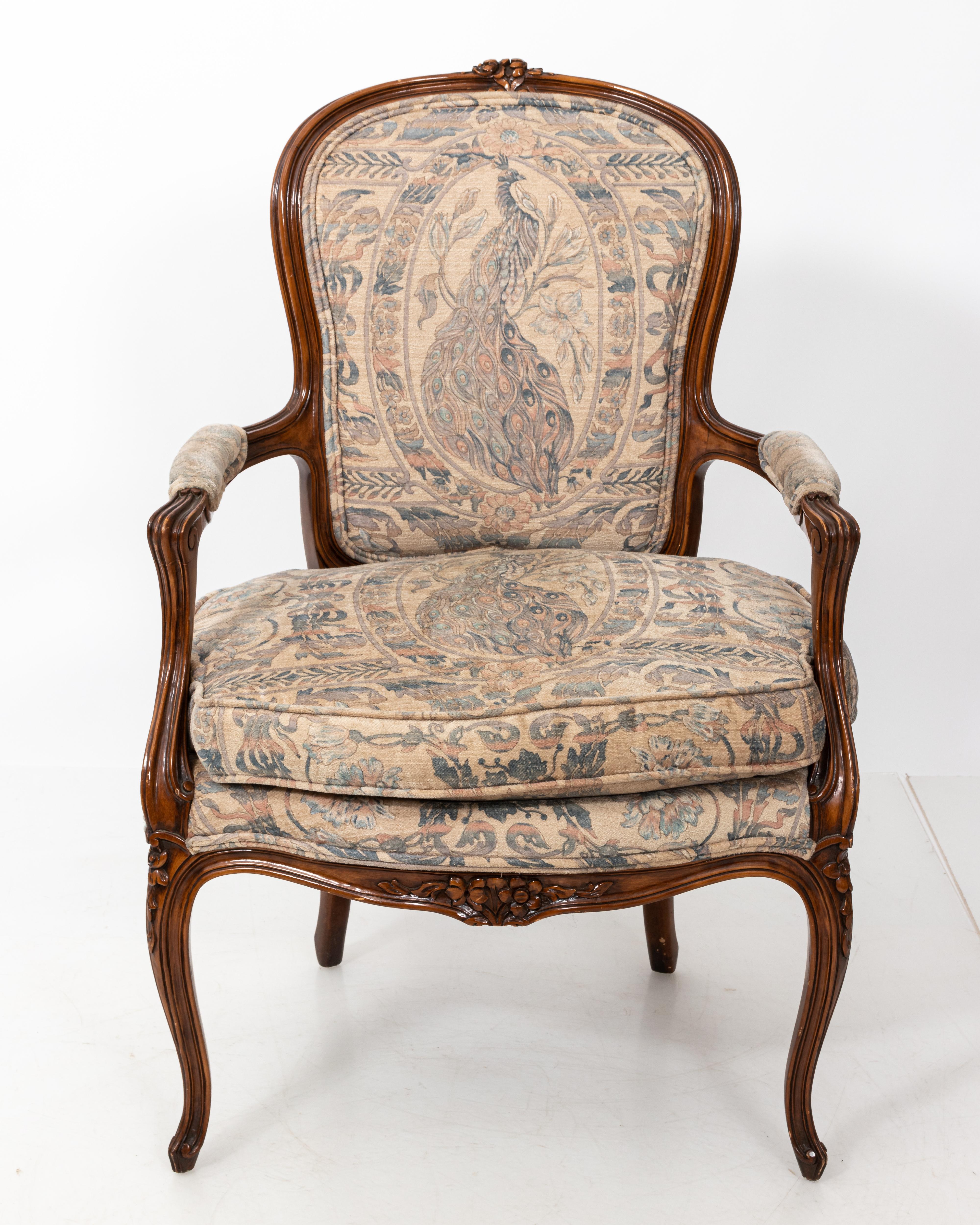 Pair of French style carved chairs in the Louis XV style. Sexy shape, Peacock upholstery. Some wear to finish.
