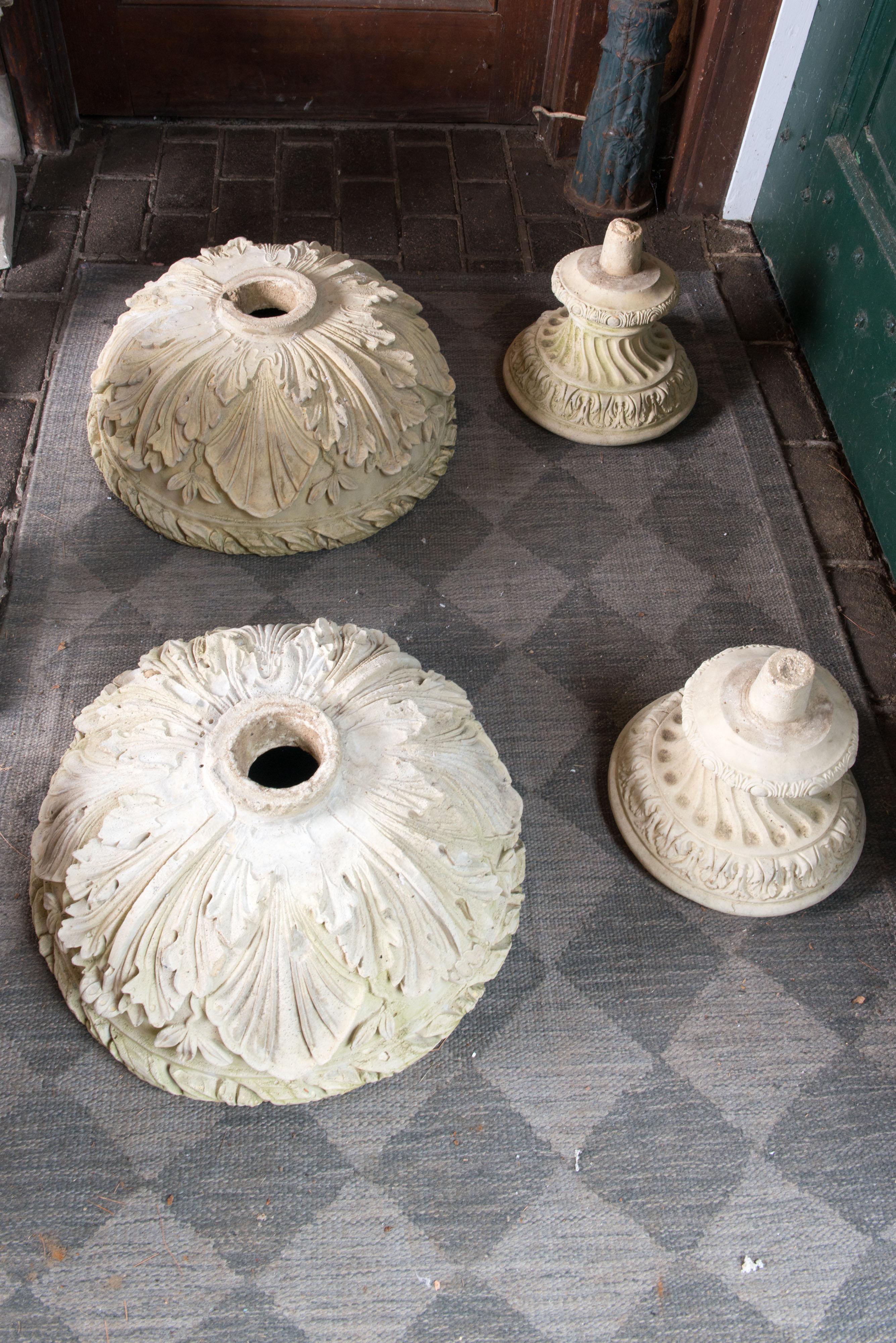 Intricately carved and cast pair of classical style urns. Yellowish-white carved pottery or aggregate with acanthus leaves on bowl, laurel and ribbon on the rim.
A handsome pair of classical style planters.