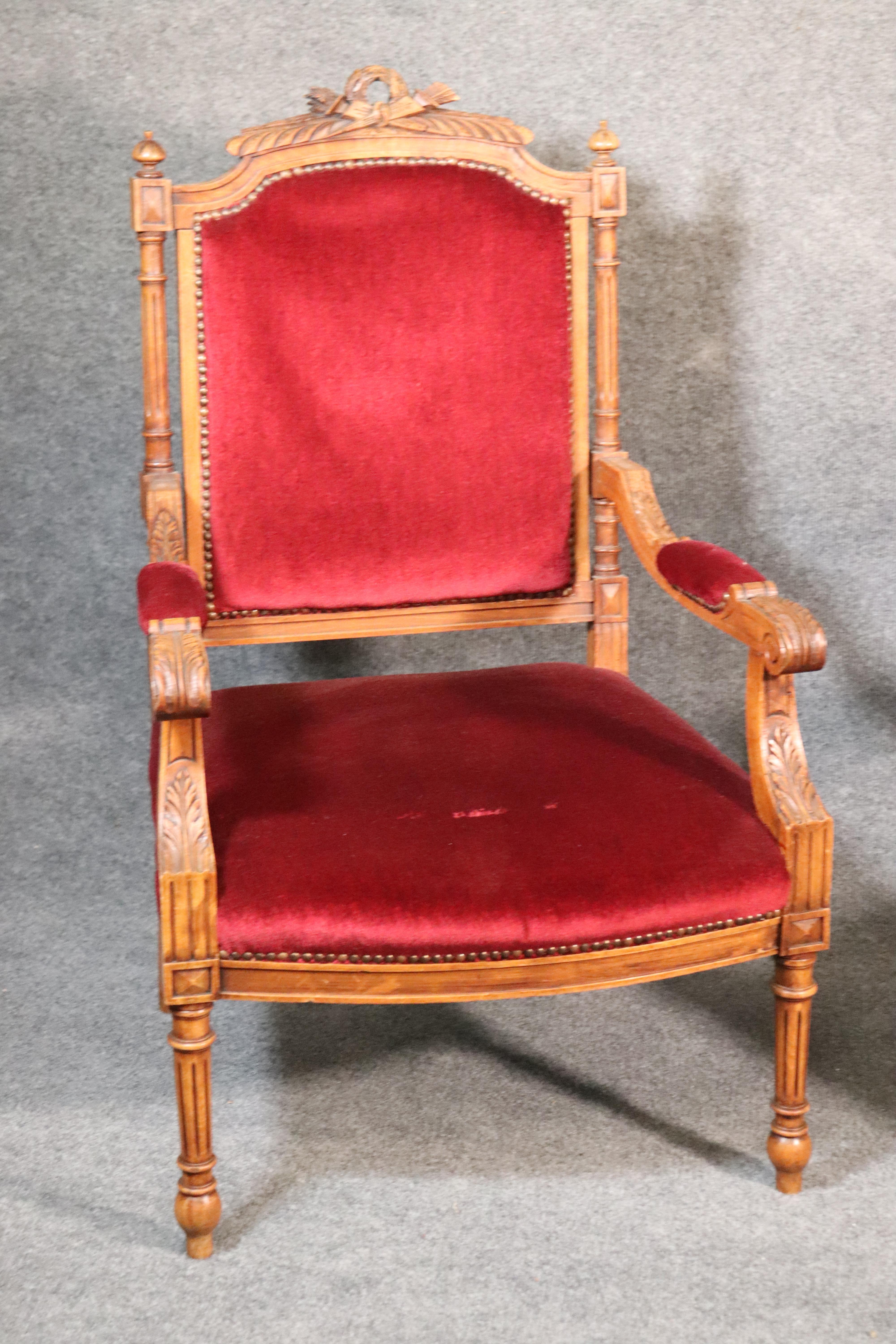 This is a gorgeous pair of French Louis XVI armchairs that are in very good condition with nice burgundy or wine hued velvet in good condition. The frames are beautifully carved and in good original condition. They measure 39.25 tall x 24.25 wide x
