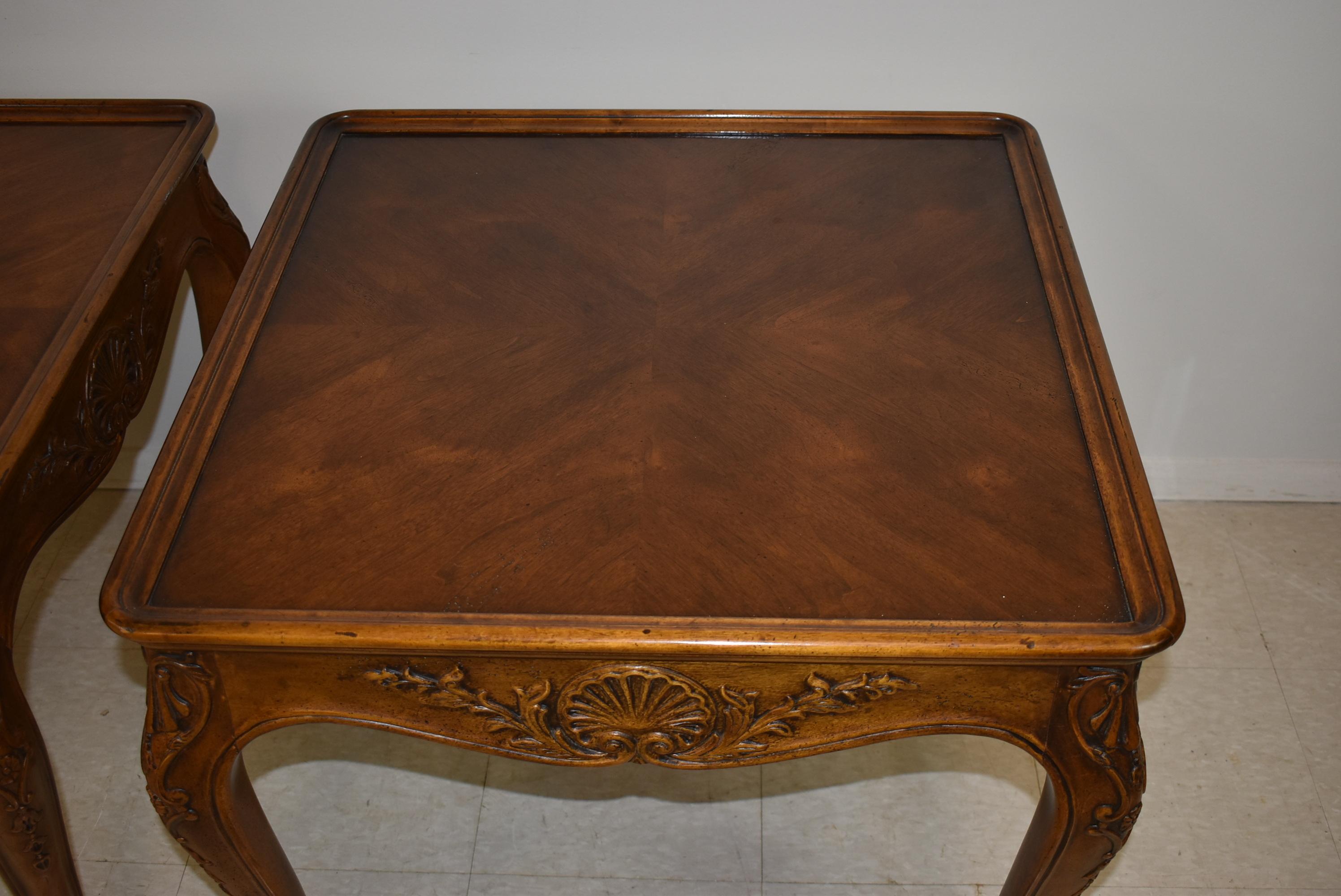 Pair of carved walnut Provincial style side tables by Henredon. Inlay patterned top.