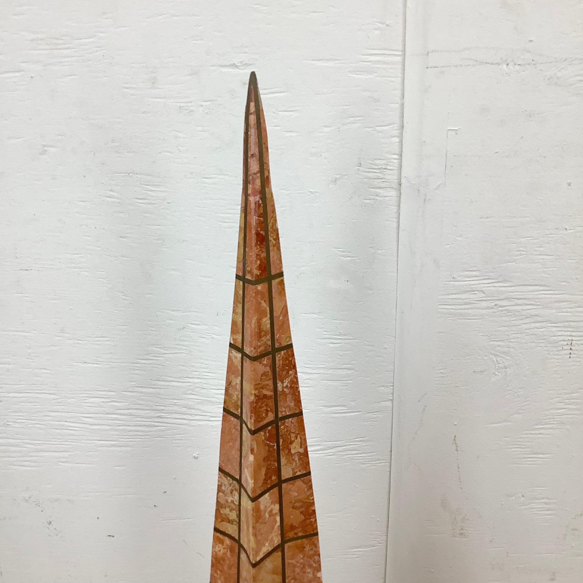 This beautiful pair of blush marble and brass grid obelisks feature the distinctive midcentury style of Robert Marcius for Casa Bique, and are often attributed to another midcentury manufacturer maitland smith. The staggered height pair of