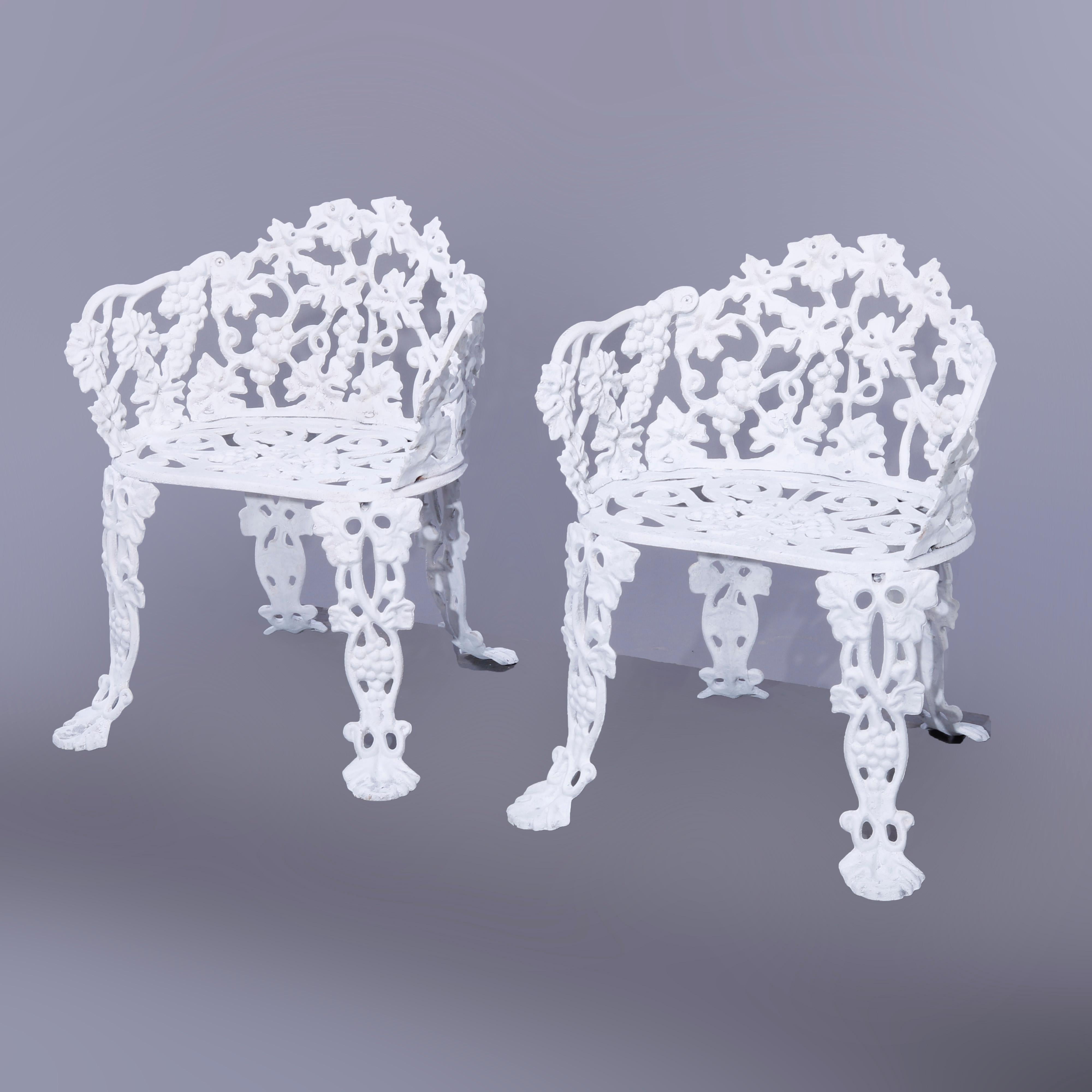 A pair of garden chairs offer cast iron construction in reticulated grape and leaf pattern, white painted, 20th century

Measures - 26.25'' H x 23'' W x 20'' D; seat height 14.5''.