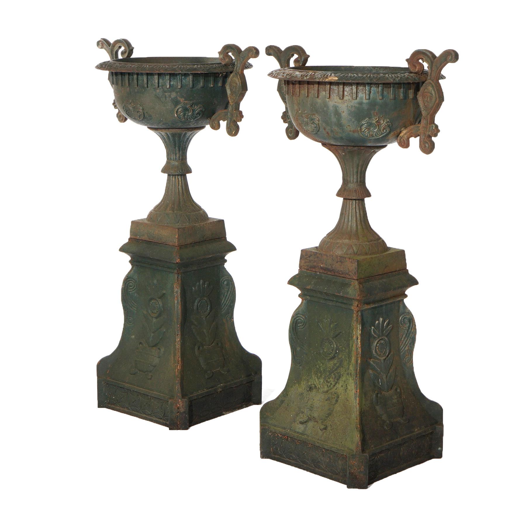 20th Century Pair Cast Iron Handled Grecian Urns on Floral Embossed Plinths 20th C