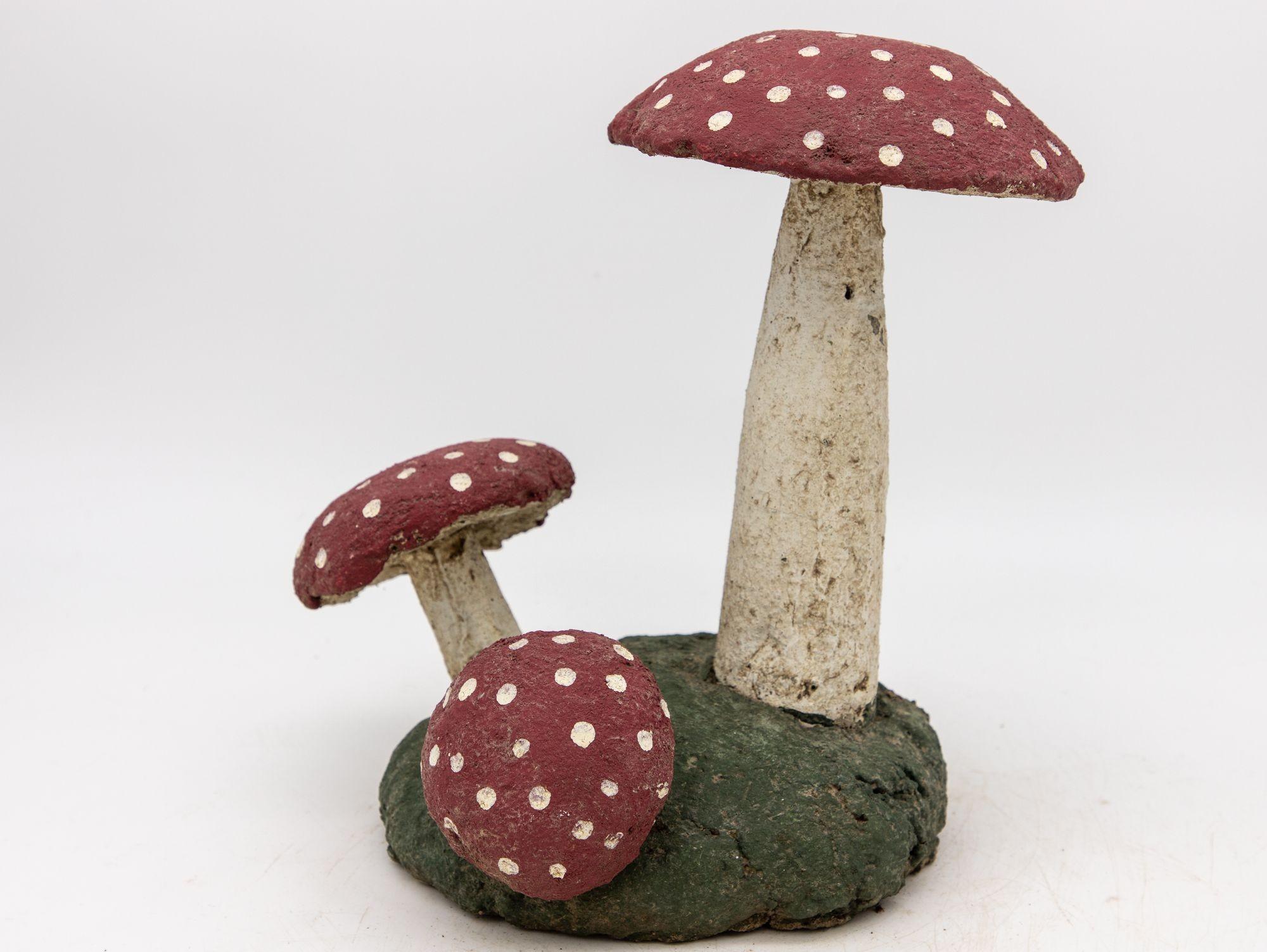 This charming pair of mid-20th century concrete mushroom garden ornaments feature a delightful blend of original red, white, and green paint that adds a vibrant pop of color to any outdoor space. These whimsical garden accents, skillfully crafted