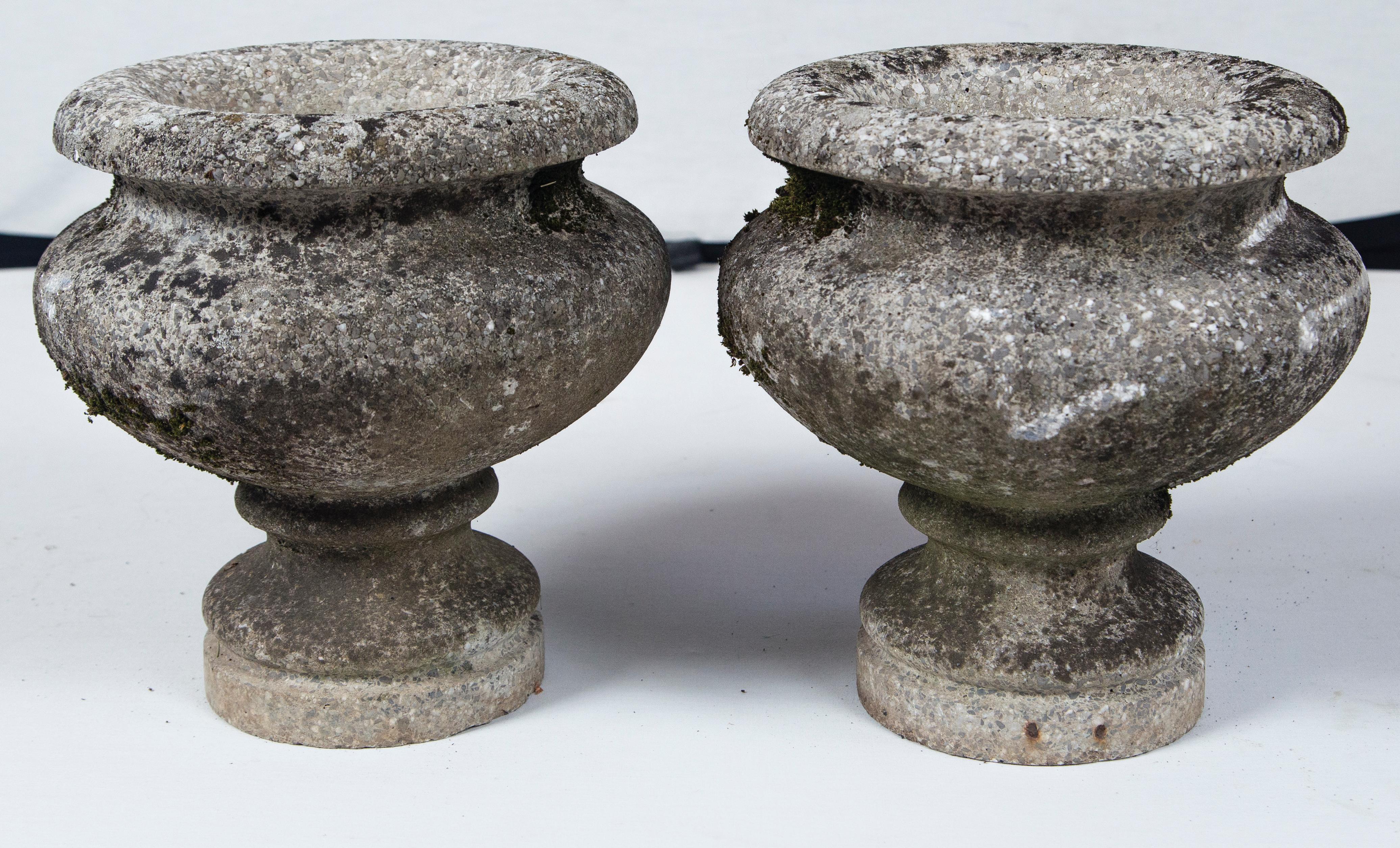 Pair of cast stone urns, France, circa 1920. A Classic shape with a lovely weathered surface.