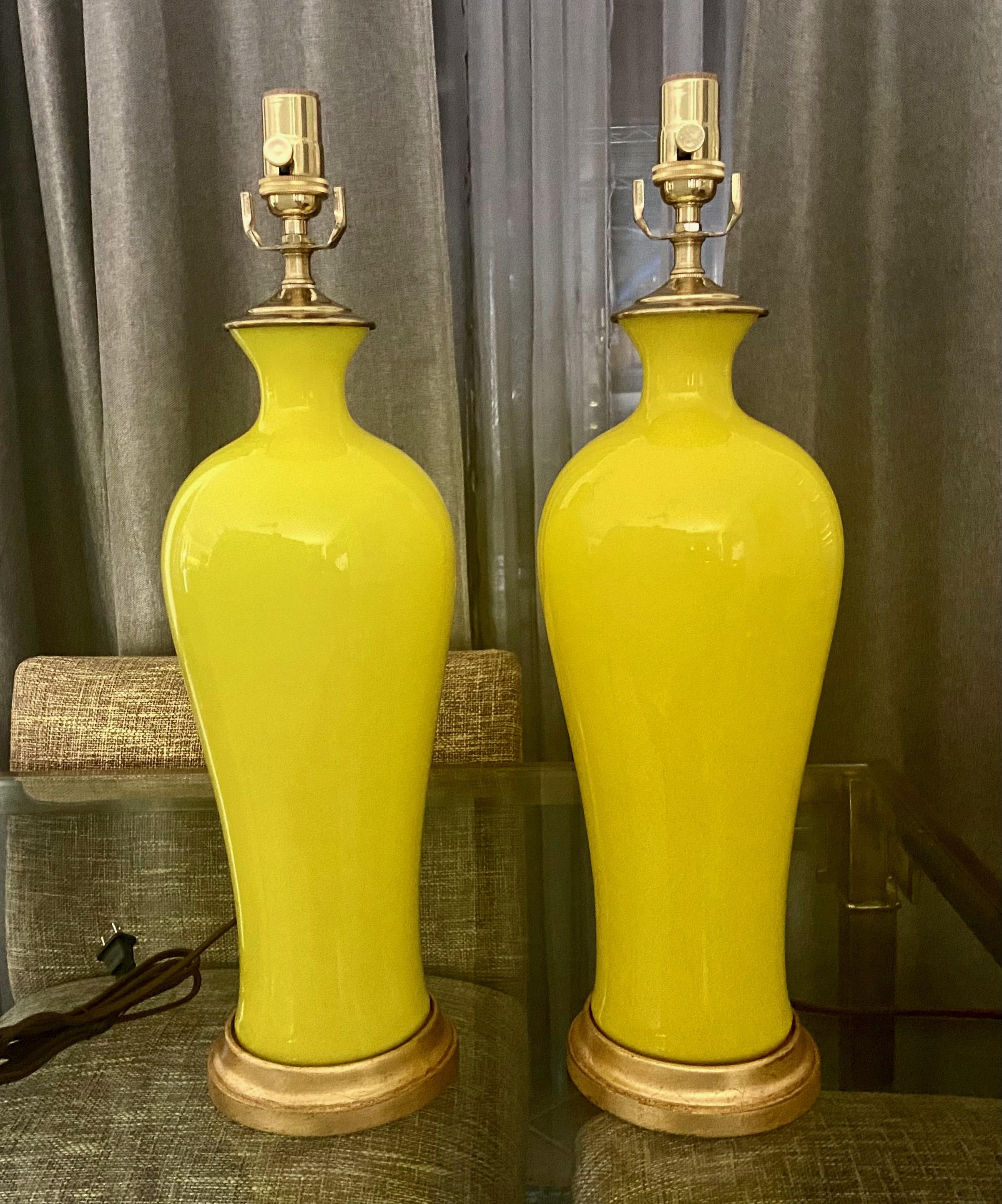Pair of Italian Cenedese hand blown bright yellow vase shape table lamps. Mounted on giltwood bases with new brass hardware. Newly wired with 3-way brass sockets and rayon covered cords. Overall height to top of socket is 23
