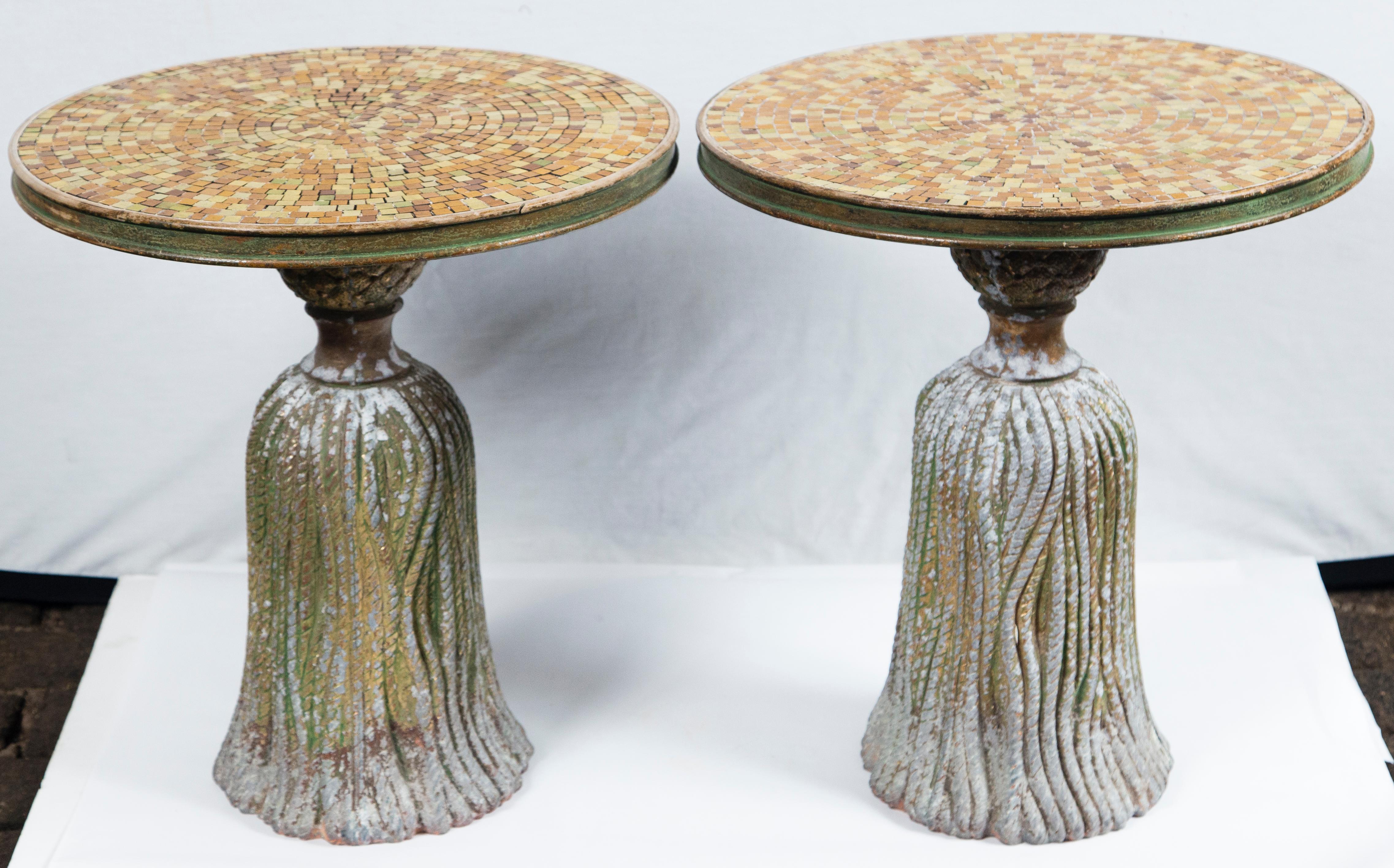 Pair of gold ceramic mosaic tile top tassel tables. Cast iron tassel shaped bases are cement filled for weight. Mosaic tops are edged with wood trim.