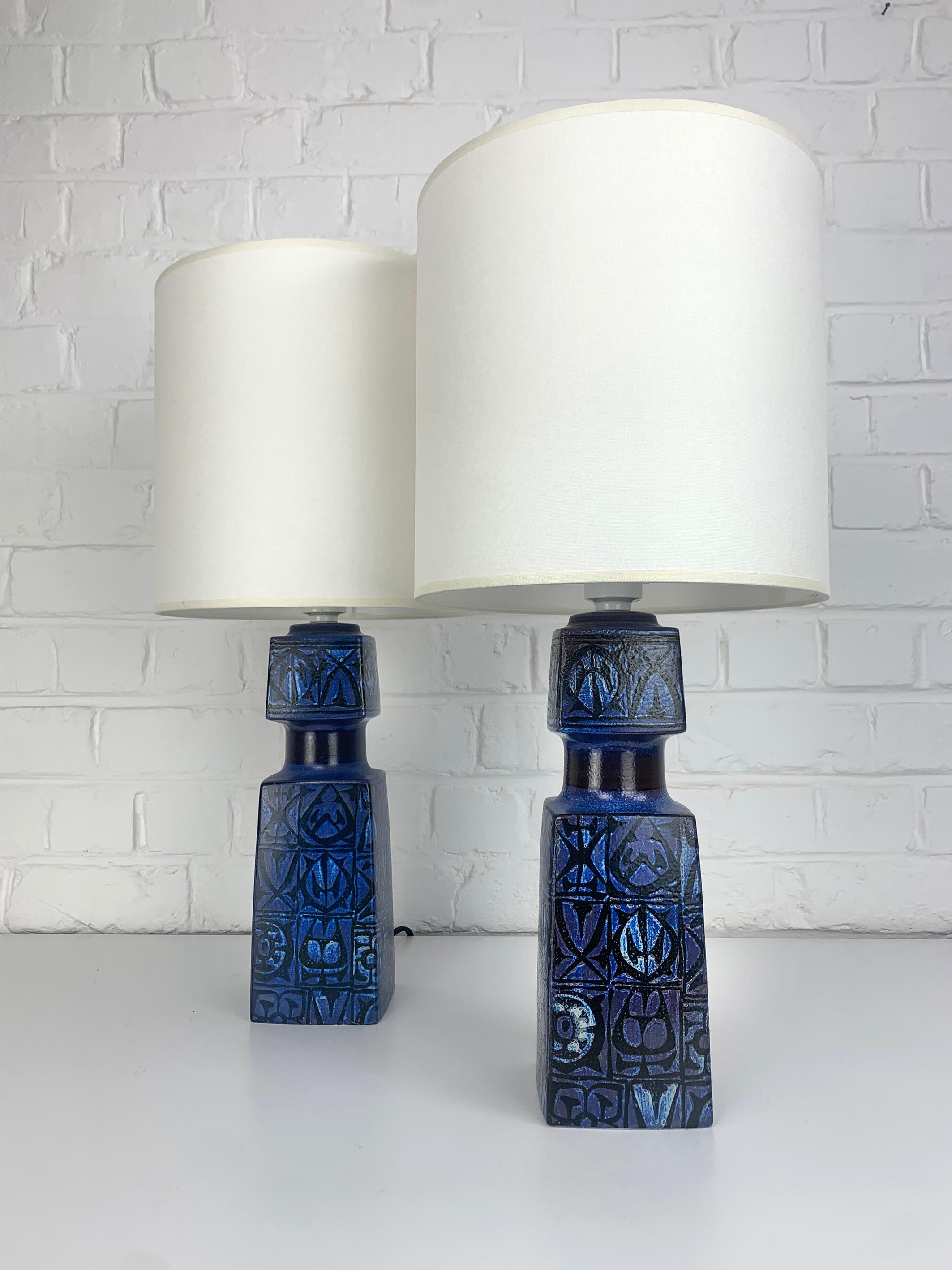 Table lamps created by Nils Thorsson, the Swedish art director of Royal Copenhagen in the 60s. 

They were produced in Denmark by Fog & Morup and distributed by Royal Copenhagen.

The lamps are decorated with abstract patterns created by Nils