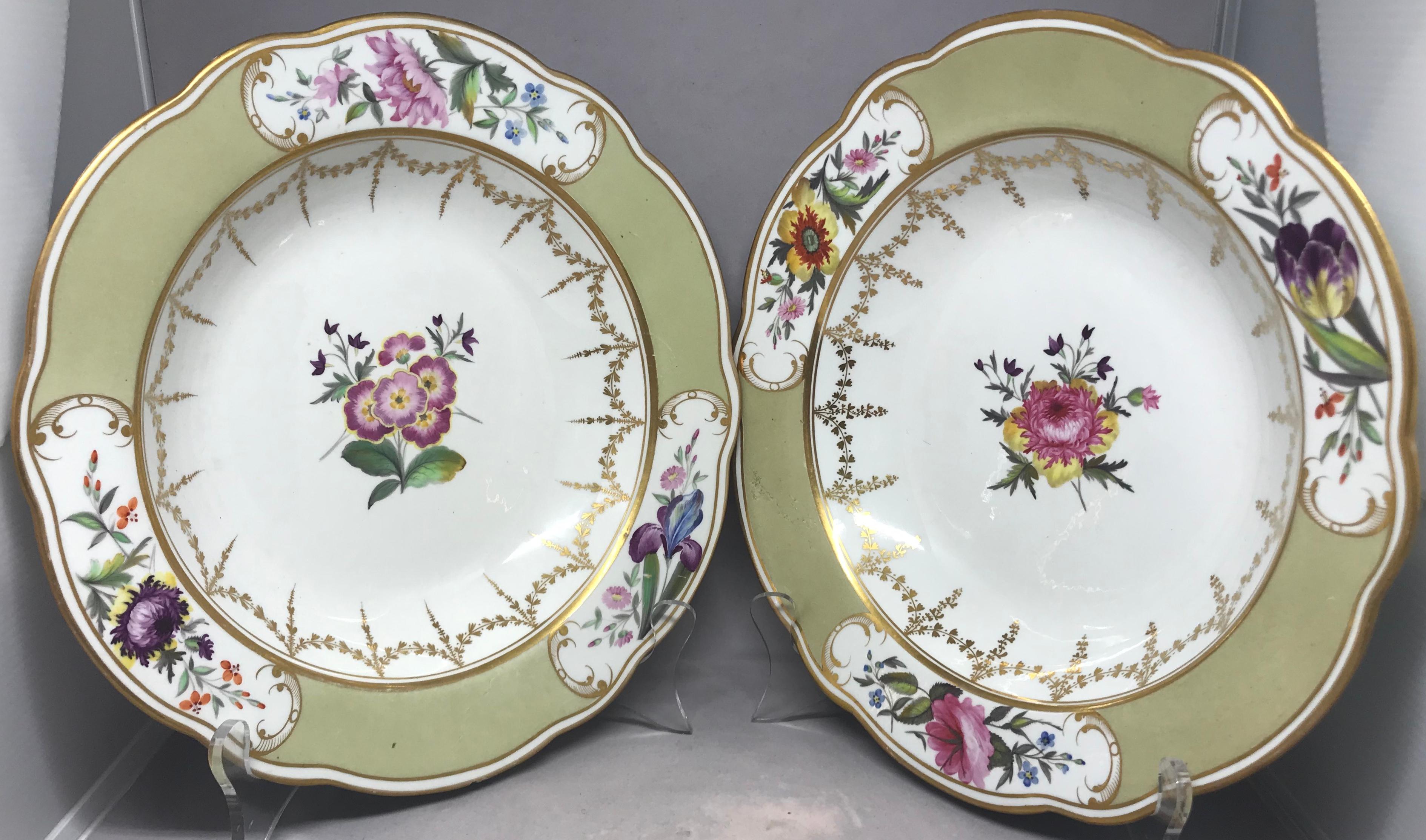 Paire d'assiettes à soupe Chamberlain Worcester. Grande paire d'assiettes à décor doré et floral avec des bordures façonnées vert pâle avec des réserves de gerbes florales et de guirlandes dorées entourant la fleur centrale. Petite retouche sur le