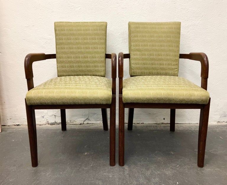 Handsome, masculine carved solid oak chairs with modernist carved arms and sharply sabred legs.  Produced by LA GENTIlHOMMIERE, Paris. Upholstered in a golden silk damask.