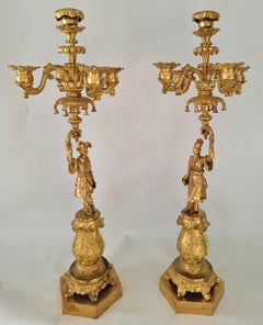 Pair Charles X ormolu candelabra held by oriental figures