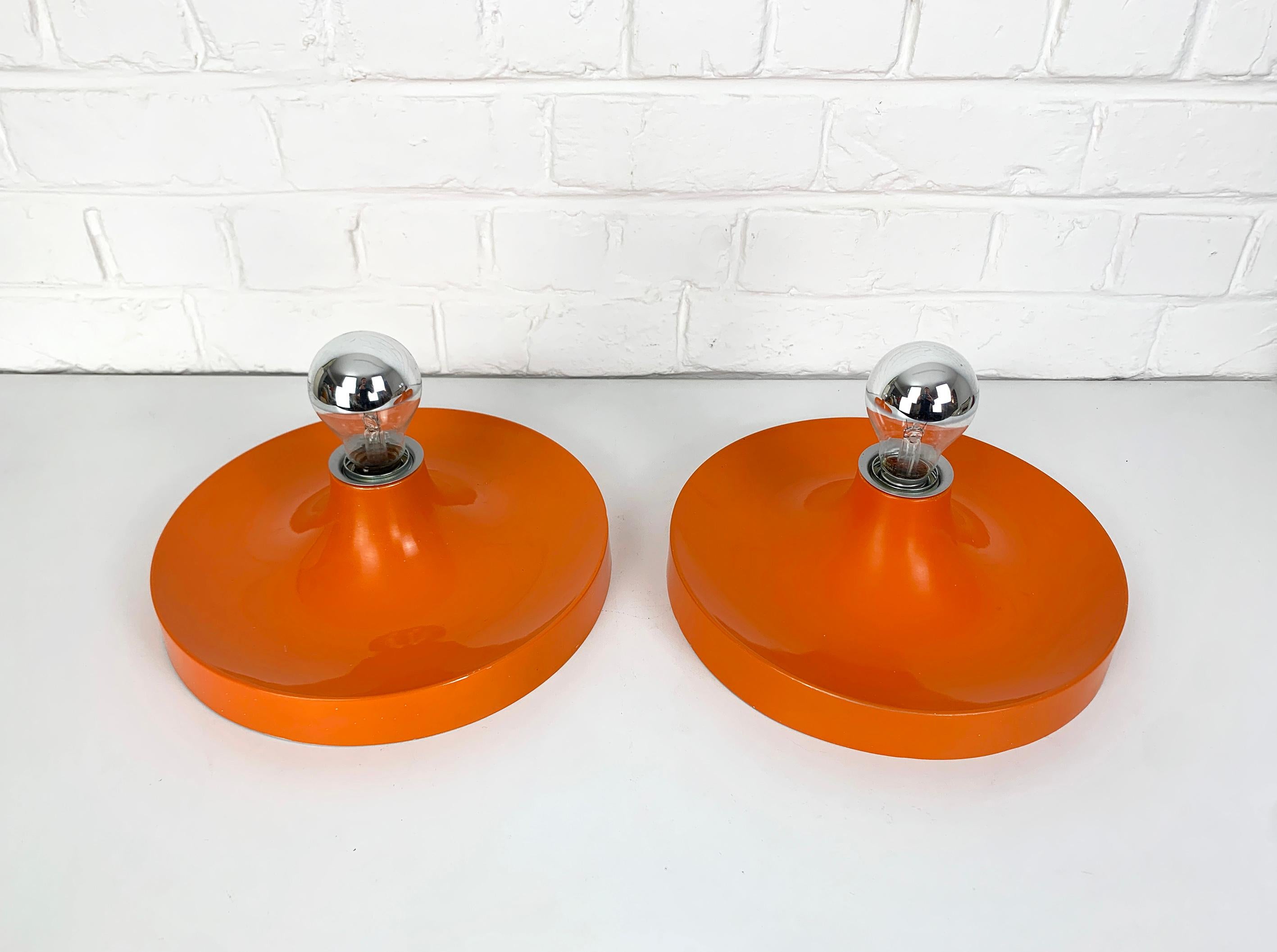 Pair of Space Age Flush lights from the 1960s, manufactured by Teka in Germany (labeled). 

These lights were commissioned / selected by Charlotte Perriand for the interior design of the flats of the 'Les Arcs' and Méribel Ski Resorts in the French