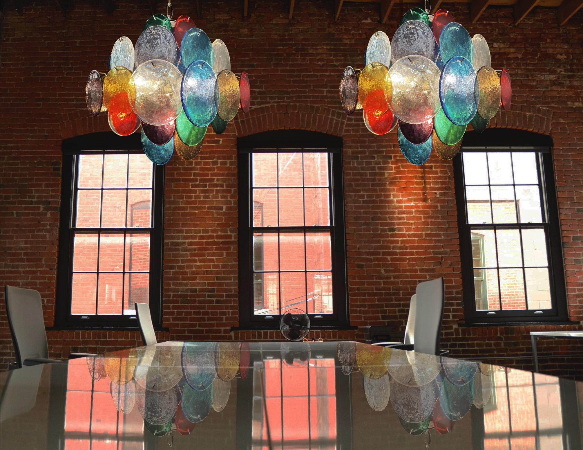 Pair Vintage Italian Murano chandeliers in Vistosi style. Each chandelier has 36 fantastic multicolored discs in a nickel metal frame.
Period: late XX century
Dimensions: 44,50 inches (150 cm) height with chain; 19,40 inches (50 cm) height without