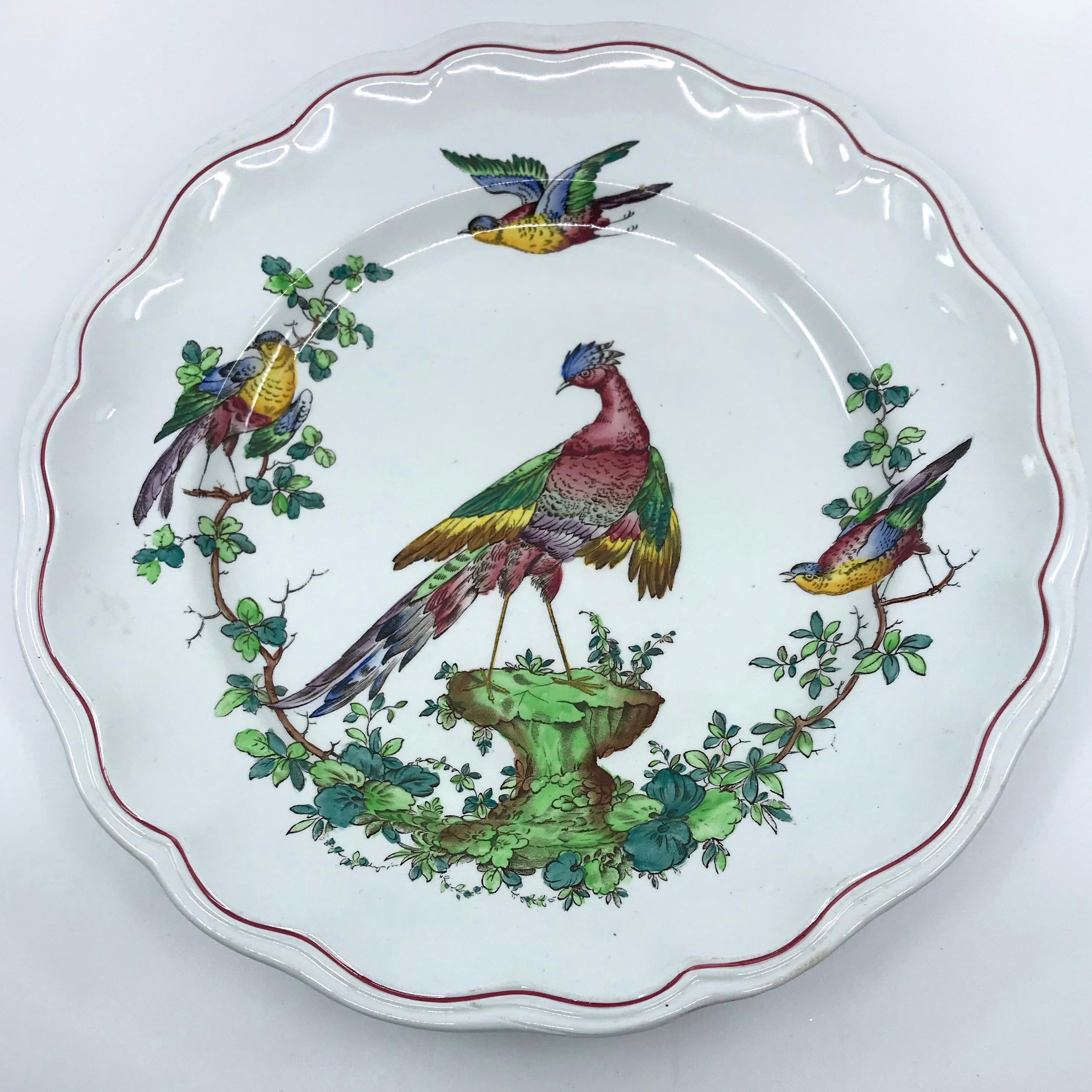 Pair Chelsea bird plates. Pair dinner plates with red painted shaped borders centering a large multicolored bird with smaller birds surrounding. England, early 20th century
Dimensions: 10.5