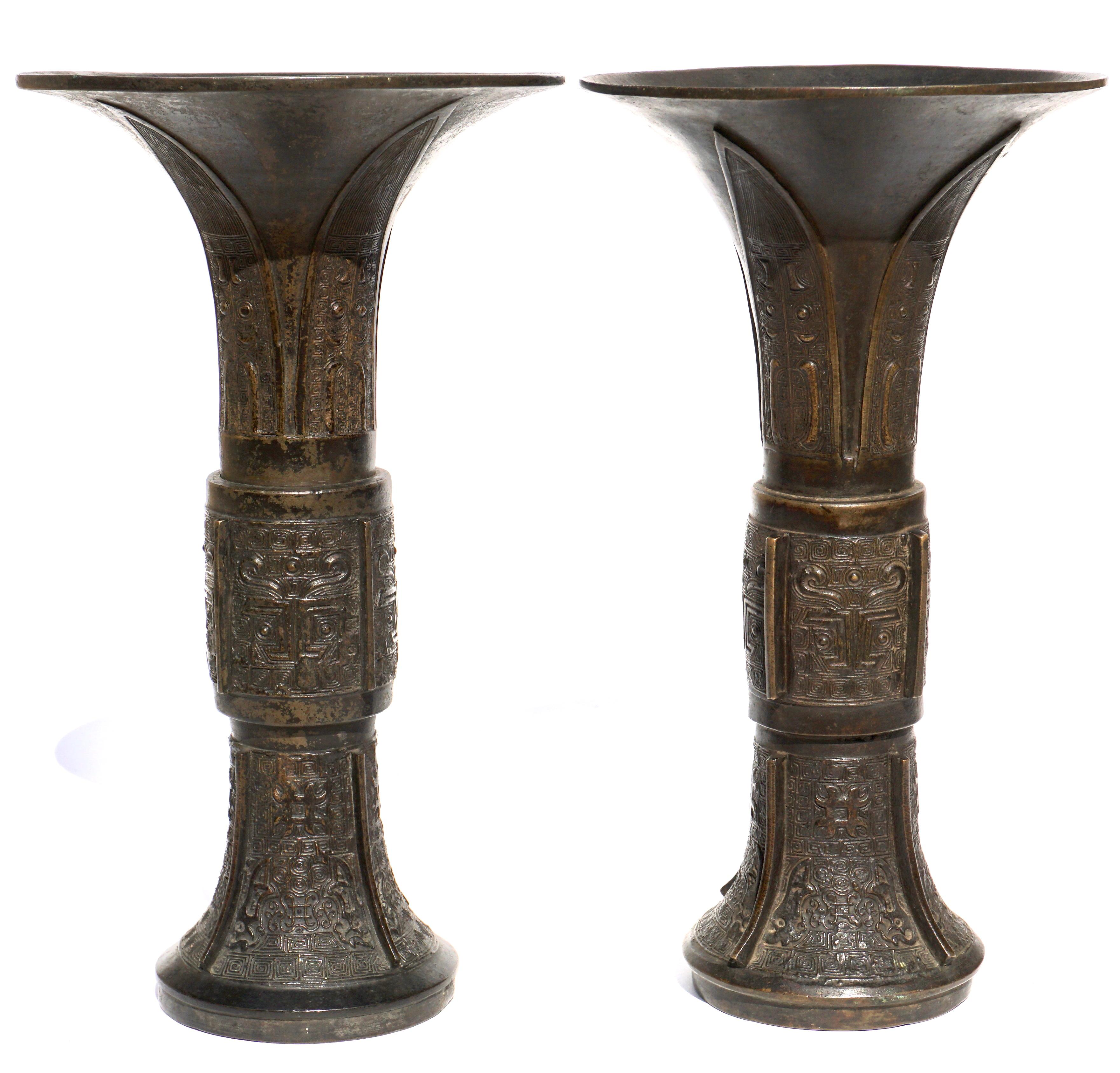 Near Pair of Chinese Archaic bronze Gu vases. 18th century Late Ming Period,
Measures: Height: 11.4 inches. Diameter: 6.4 Inches
Condition: Very good with losses to patina, scratches and wear commensurate of age and use. .75 Inch anomaly on upper