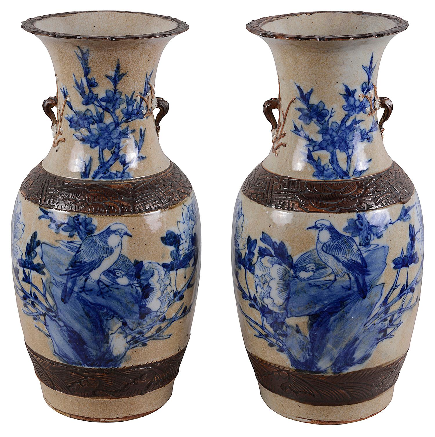 Pair of 19th century Chinese blue and white crackleware vases, each with brown colored engraved bands, and blue and white scenes of Doves on a rocky outcrop surround by flowers and leaves.
We can have these vases wired as lamps if required within