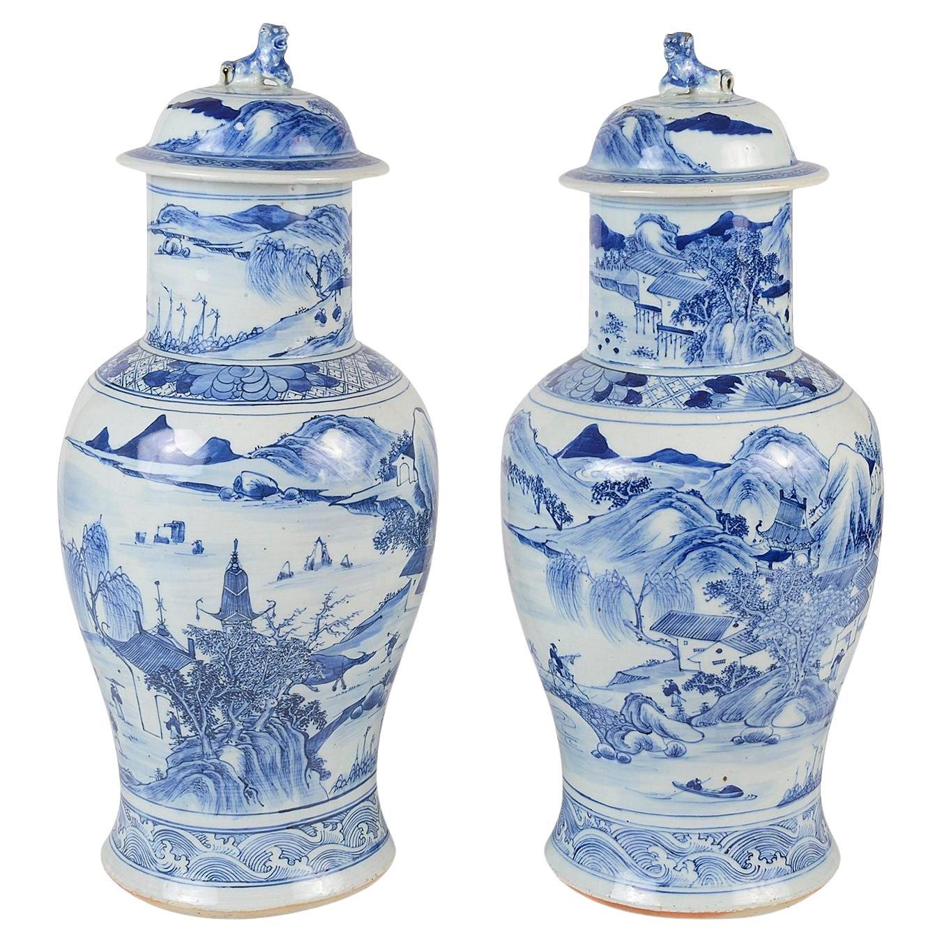 Pair Chinese 19th Century Blue and White lidded vases.
