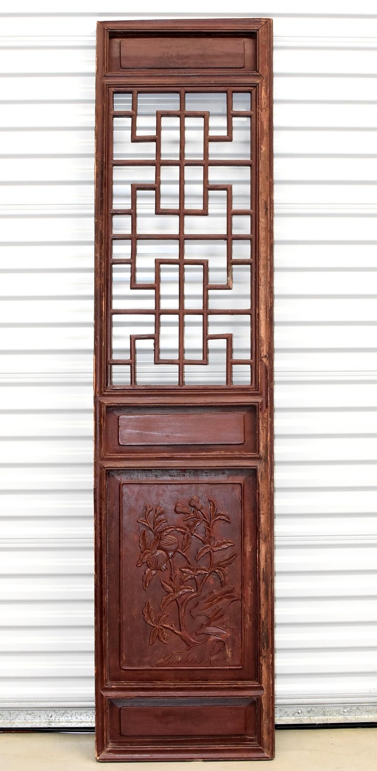 This is a pair of beautiful, early 20th century Chinese antique door screens. The top section is formed by a Chinese longevity pattern, which are created by joining custom-cut pieces of wood using tenons and mortises, an incredibly painstaking
