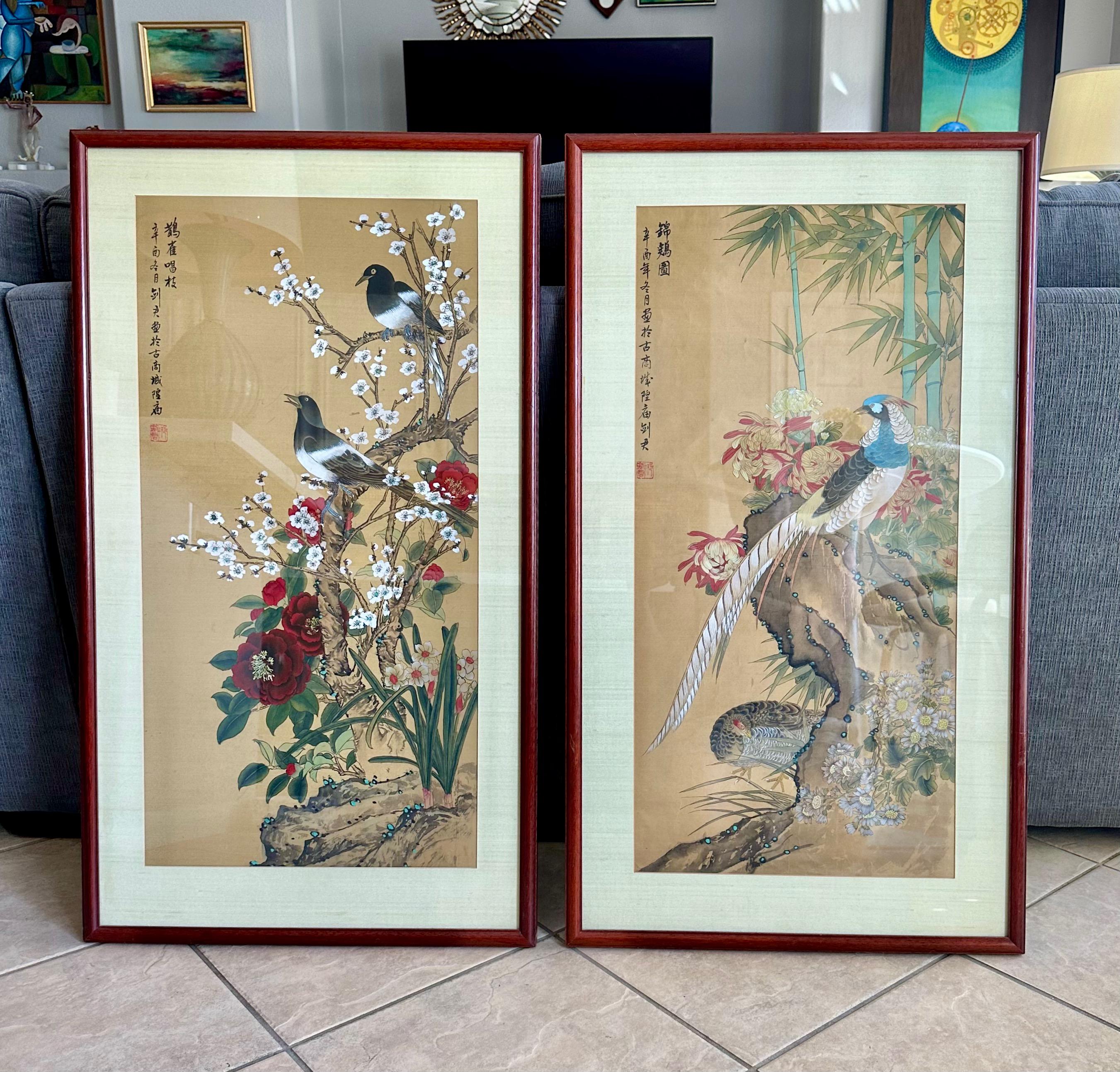 Pair tall framed and matted Chinese silk water color paintings depicting exotic birds and flowers and shrubbery. Both with calligraphy inscription and red seal. Expertly crafted with bright vidid colors.