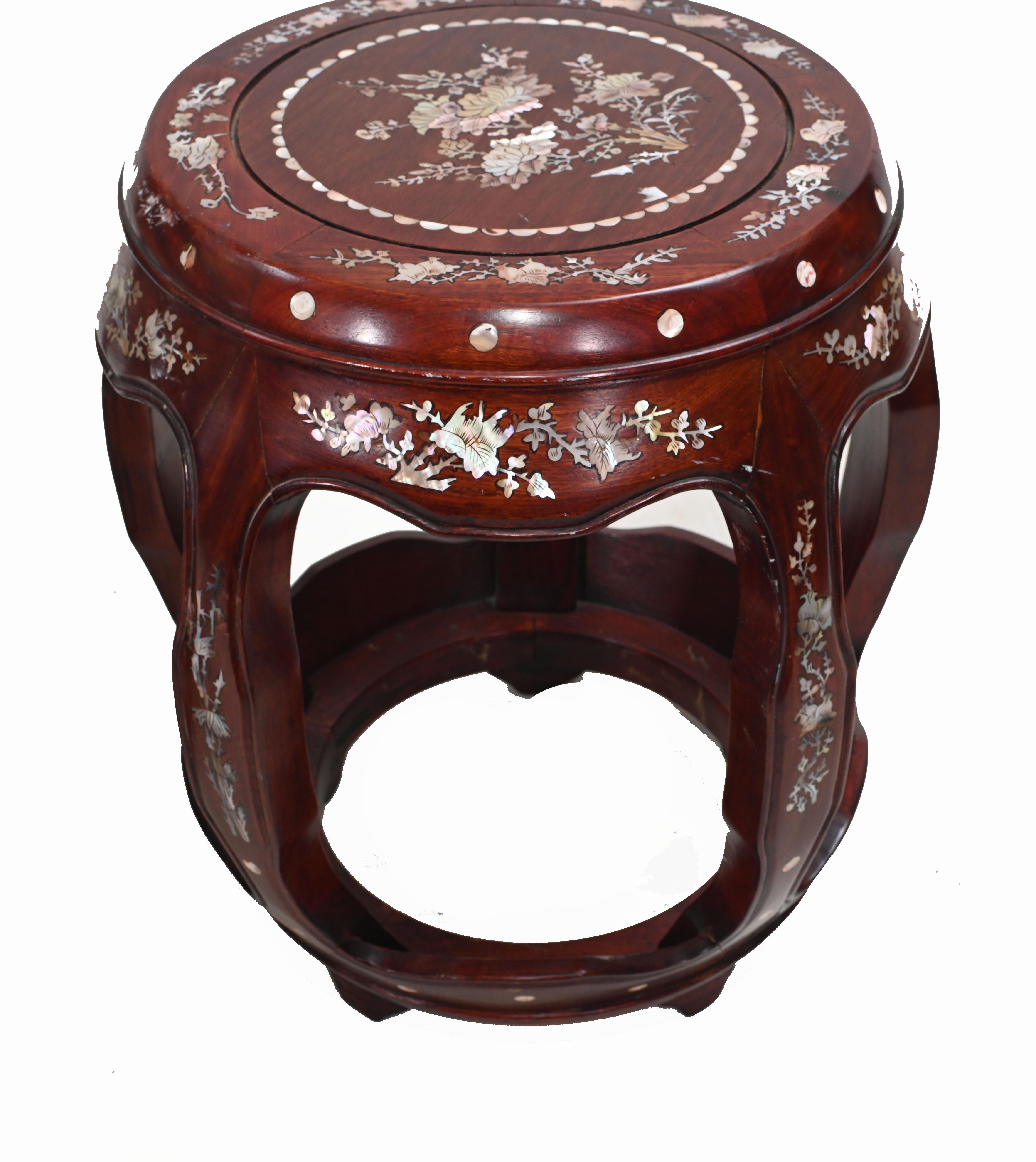 Elegant pair of Chinese pedestal stands in hardwood
Features intricate mother of pearl inlay work 
Great for displaying decorative pieces such as urns or vases
Circa 1930 
Some of our items are in storage so please check ahead of a viewing to