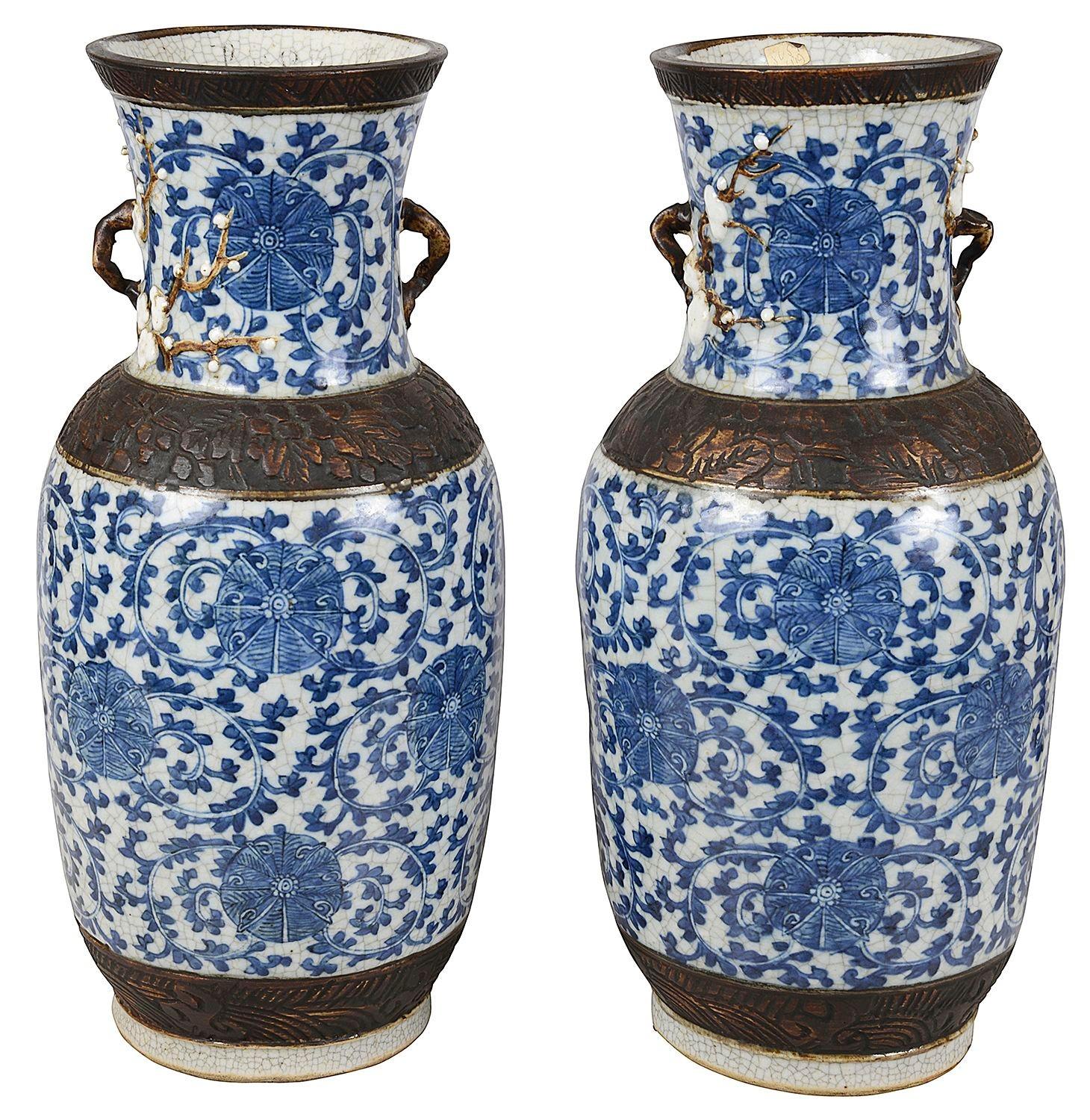A good quality pair of late 19th Century Chinese blue and White crackleware vases / lamps. Each with bronzed scrolling impressed boaders and handles. The crackleware ground with scrolling blue and white foliate decoration with motifs within.
The