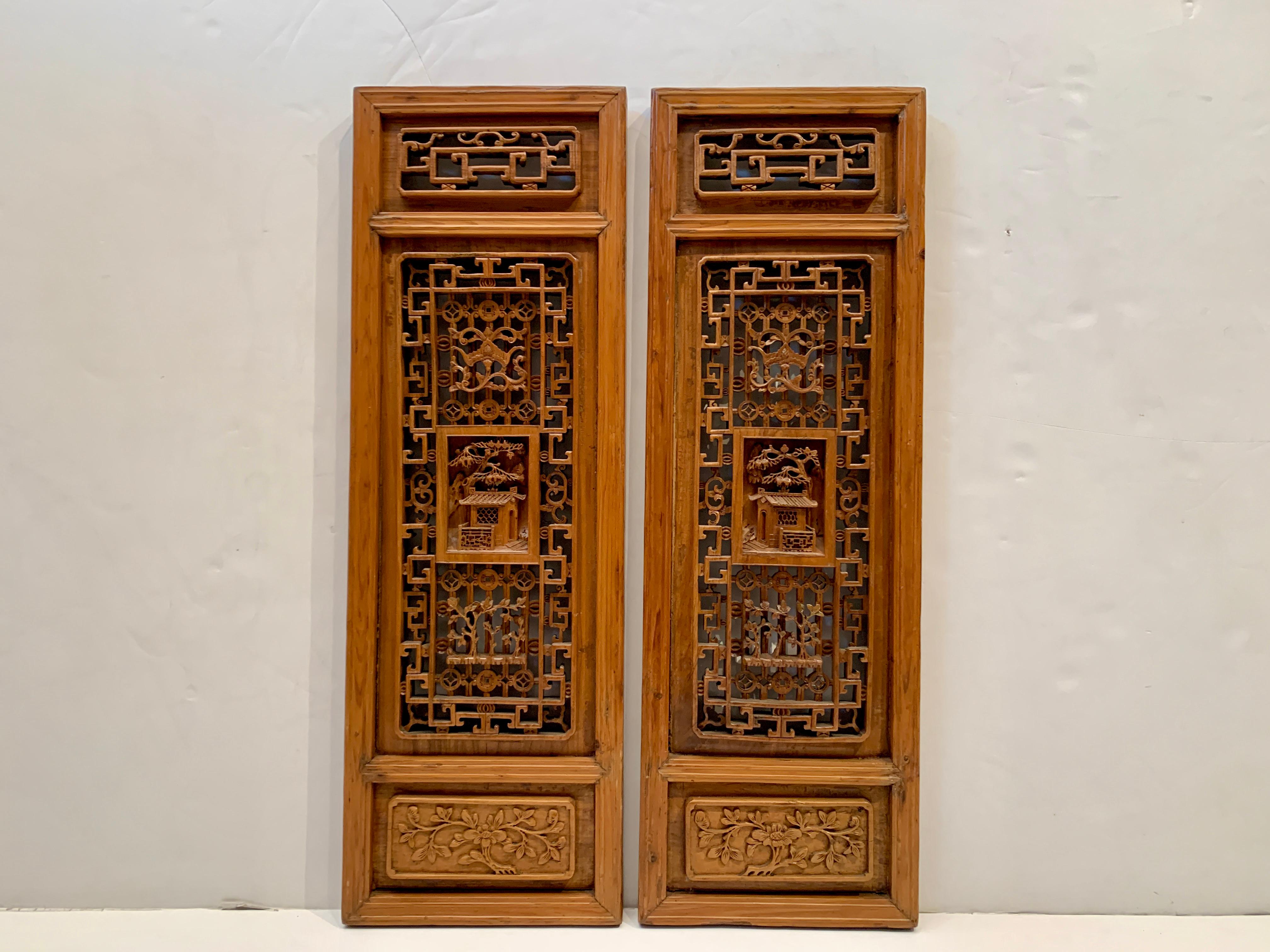 A pair of gorgeous and well carved late Qing Dynasty Chinese carved and pierced window screen panels, early 20th century, China.

The window screen panels are constructed of elm wood, with a solid frame encompassing three carved floating panel