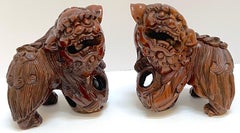 Pair Chinese Carved Hardwood Foo dogs with Rolling Pearls & Puzzle Balls